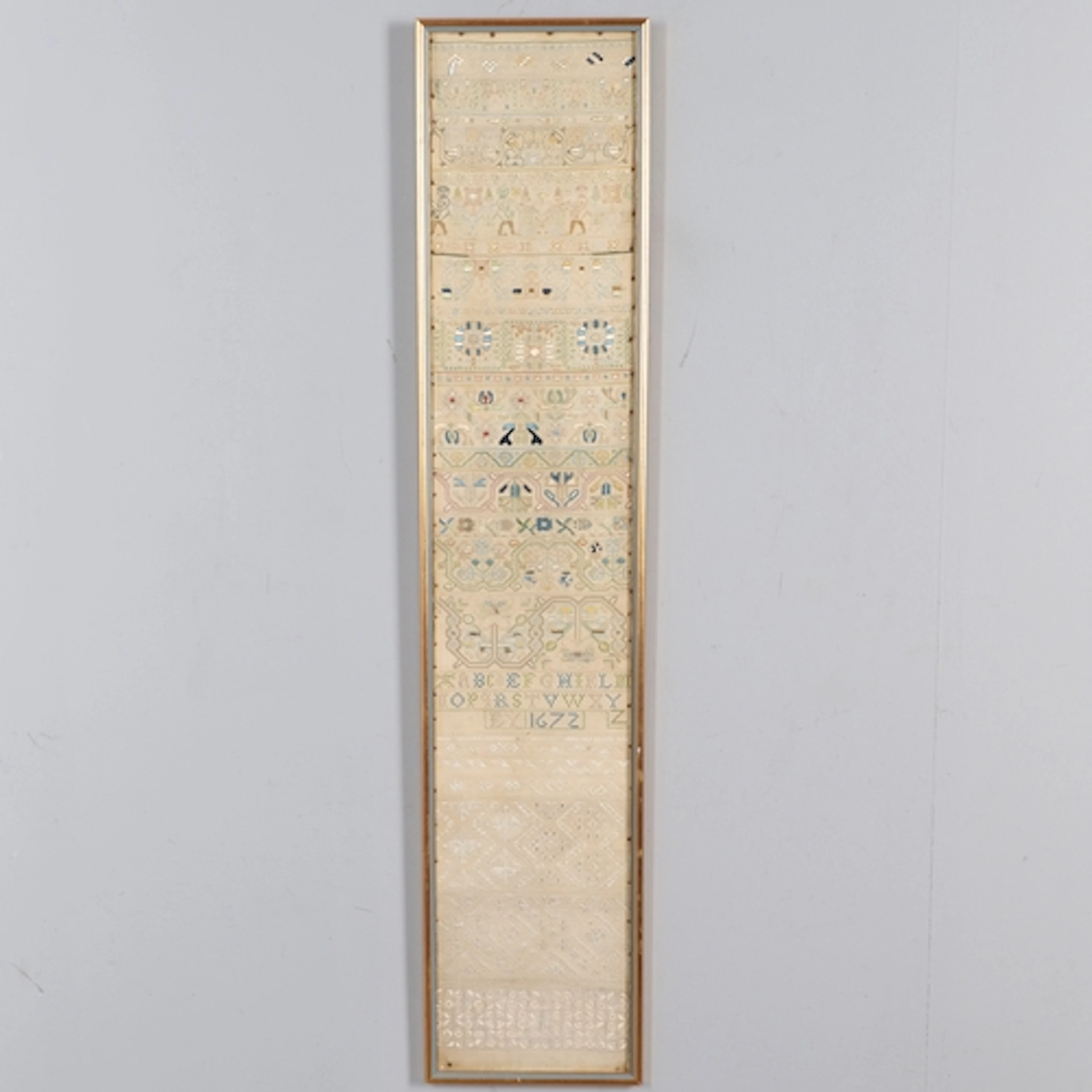 A 17TH CENTURY NEEDLEWORK BAND SAMPLER. worked in various po...