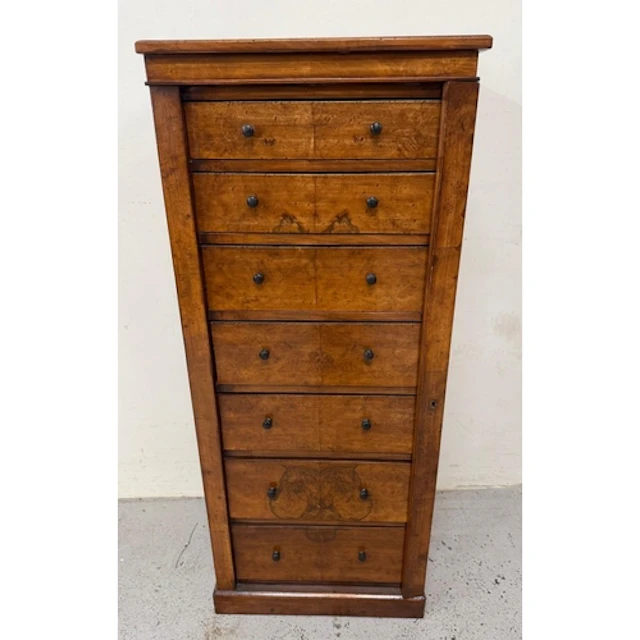 A Victorian wellington chest featuring graduated drawers and...