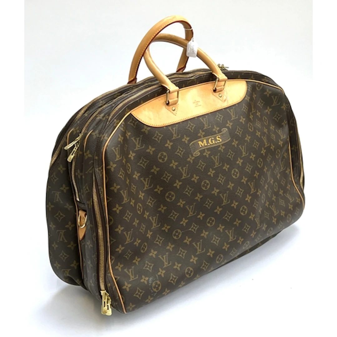 A Louis Vuitton monogrammed three compartment travel bag, ap...