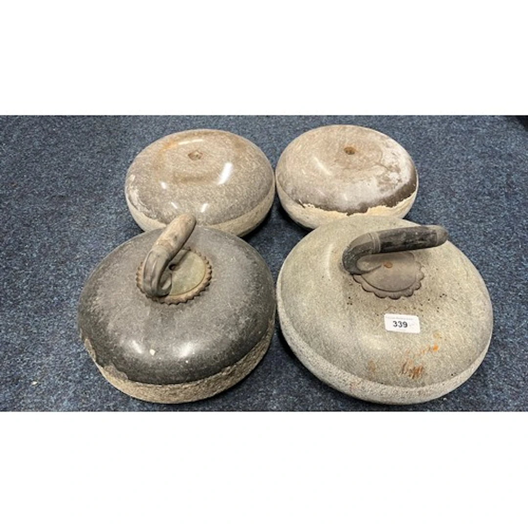 Group of four curling stones.