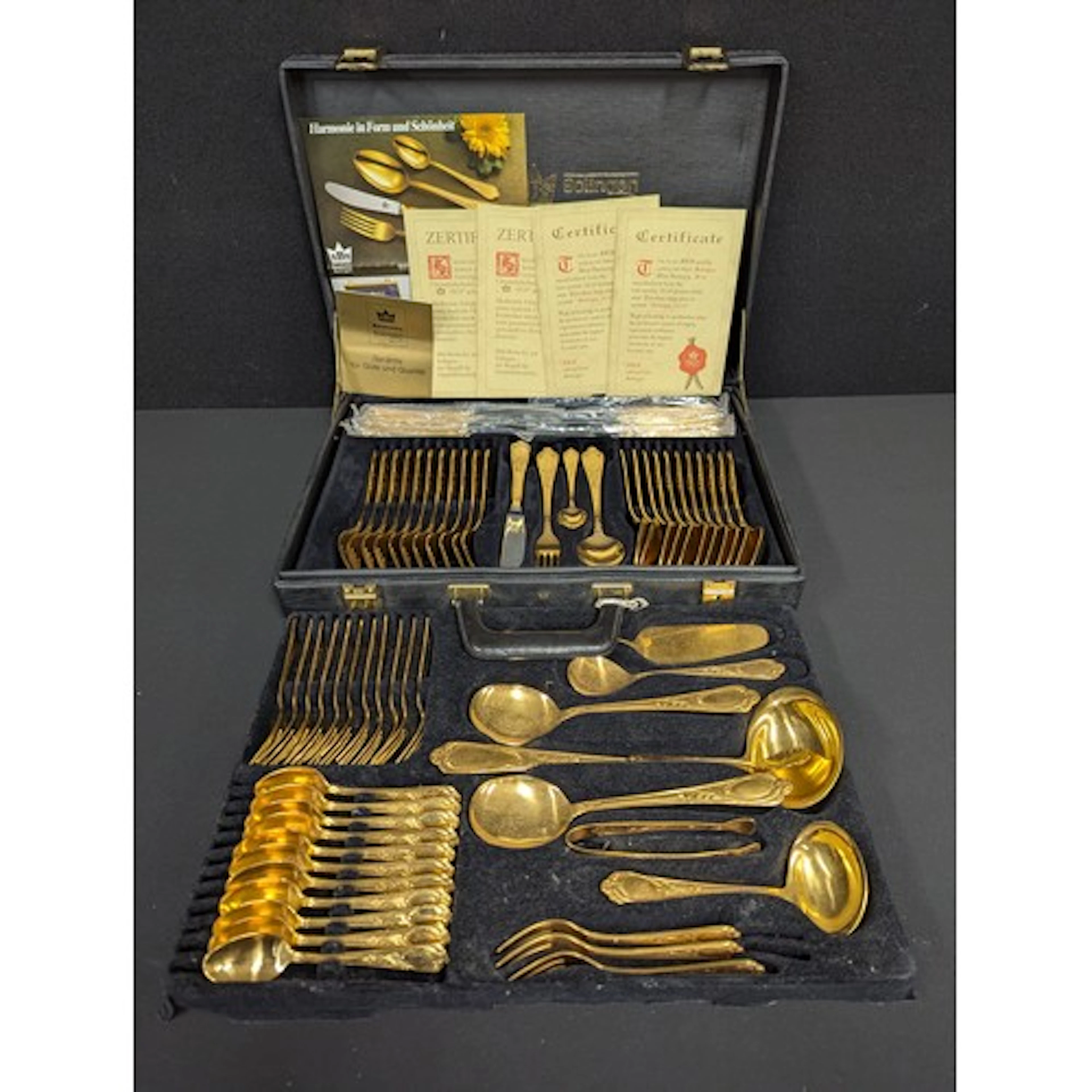 A Bestecke Solingen gold plated canteen for twelve, with cer...
