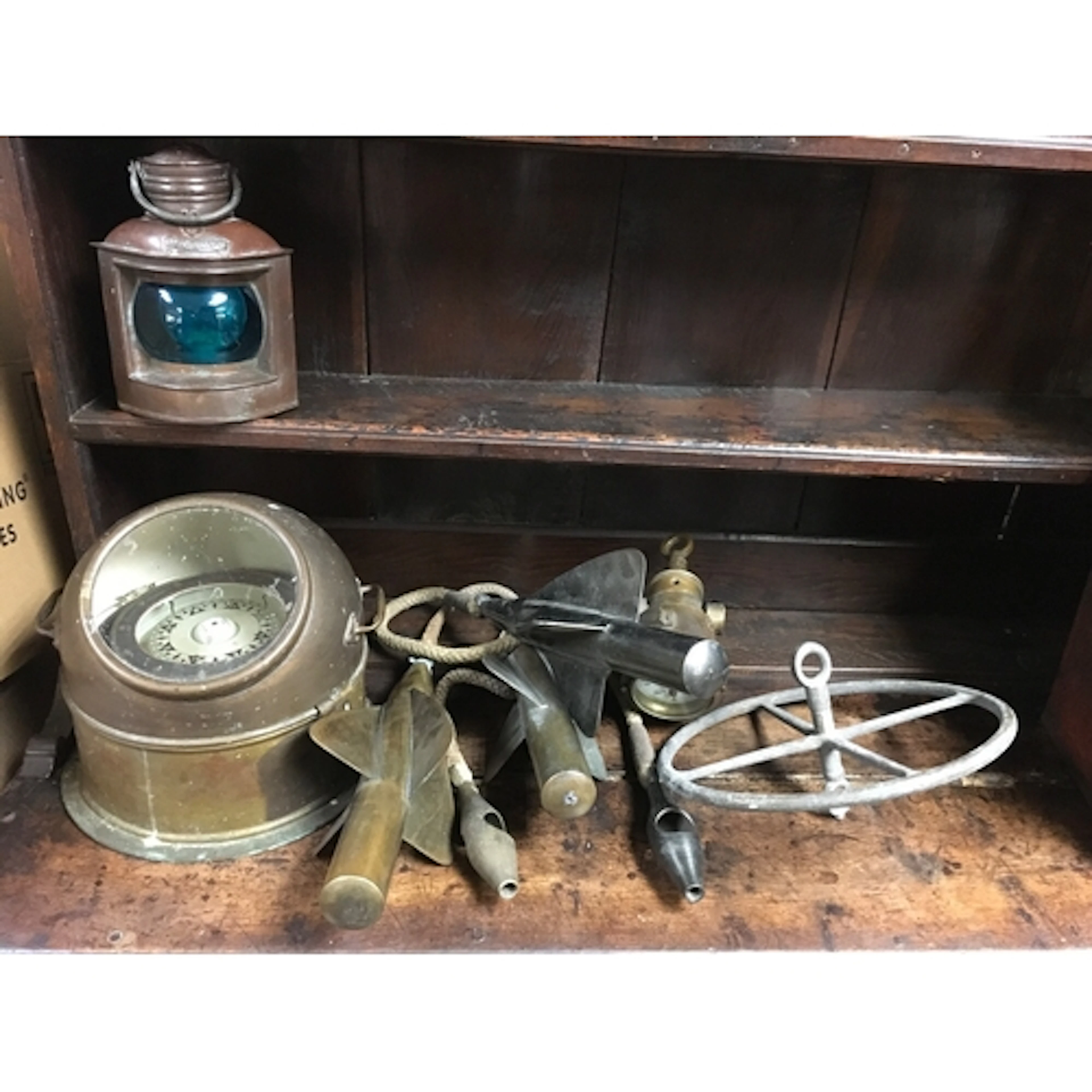 A collection of nautical items including compass, three spin...