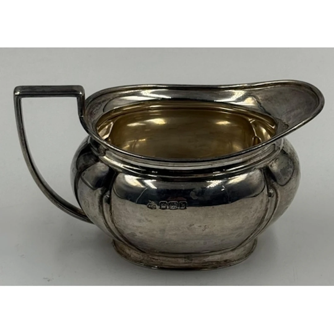 A hallmarked silver milk jug by John Turton & Co Sheffie...