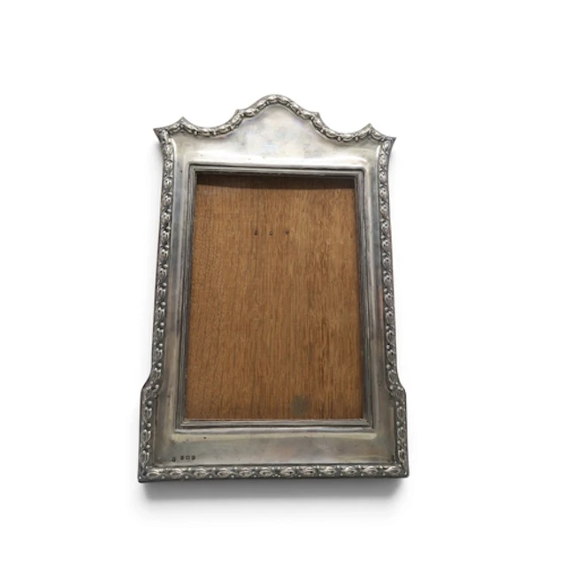 An Edwardian silver photo frame by Charles S. Green & Co...