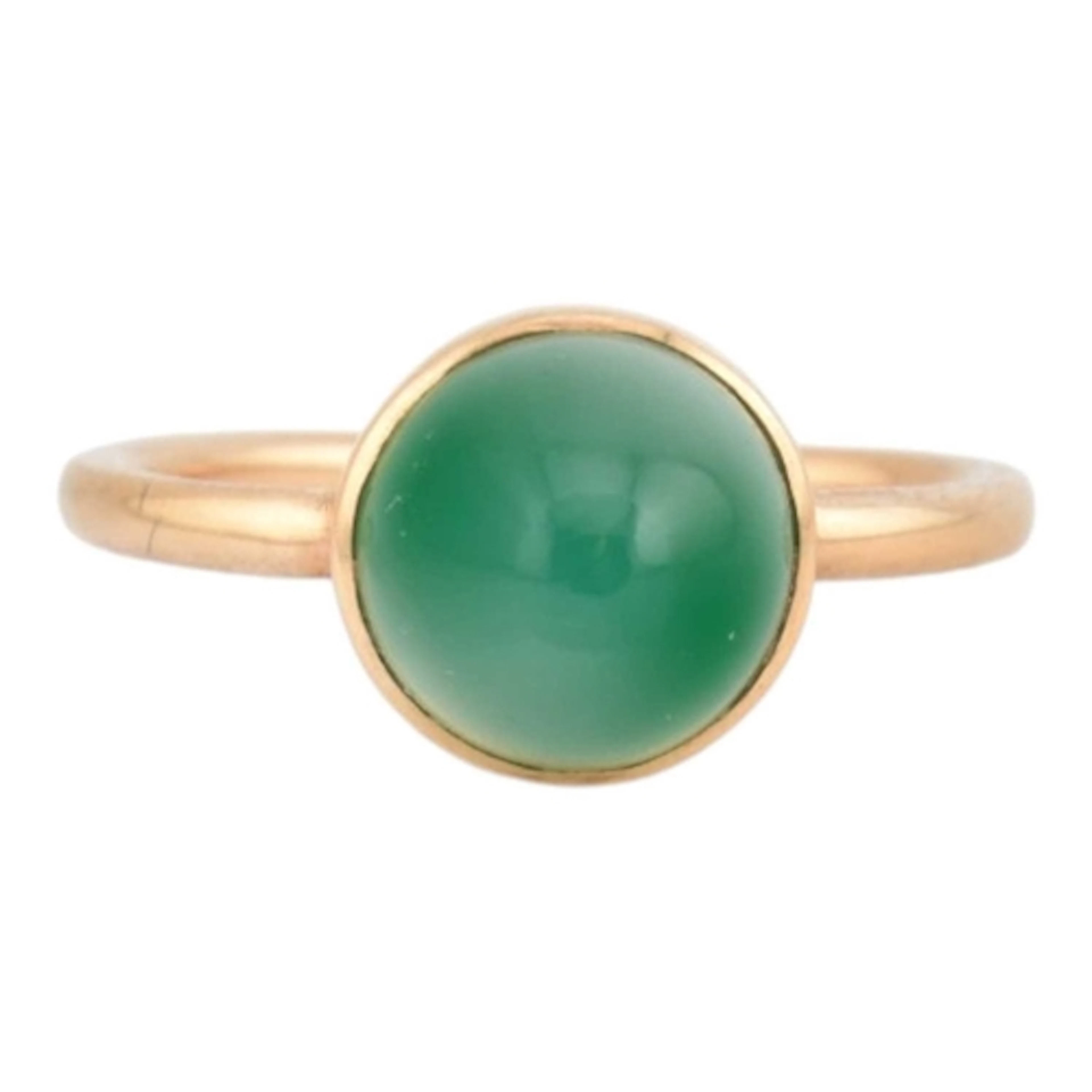 A gold and chalcedony cabochon ring. The ring is set with a ...