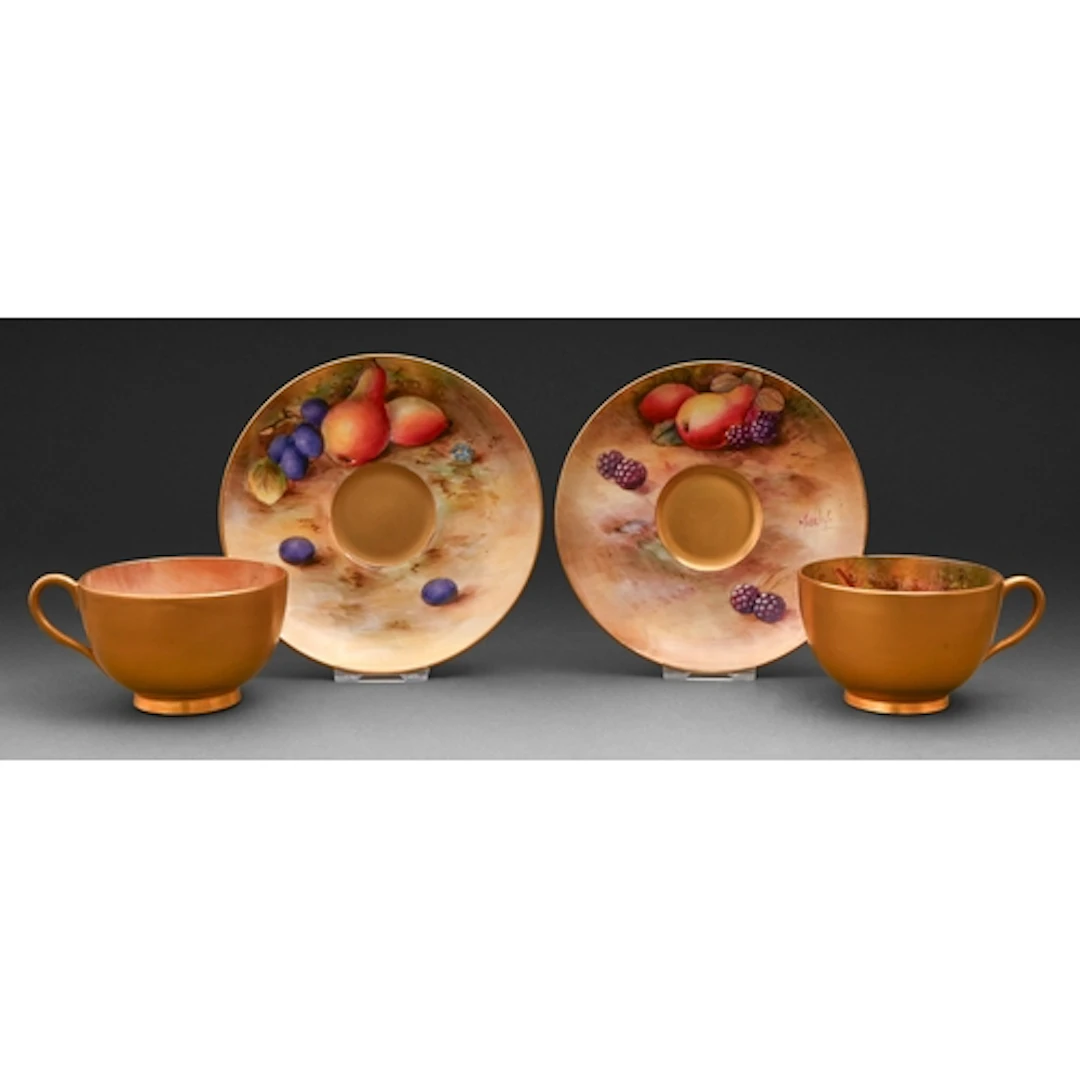 A pair of Royal Worcester teacups and saucers, 1926 and 1929...