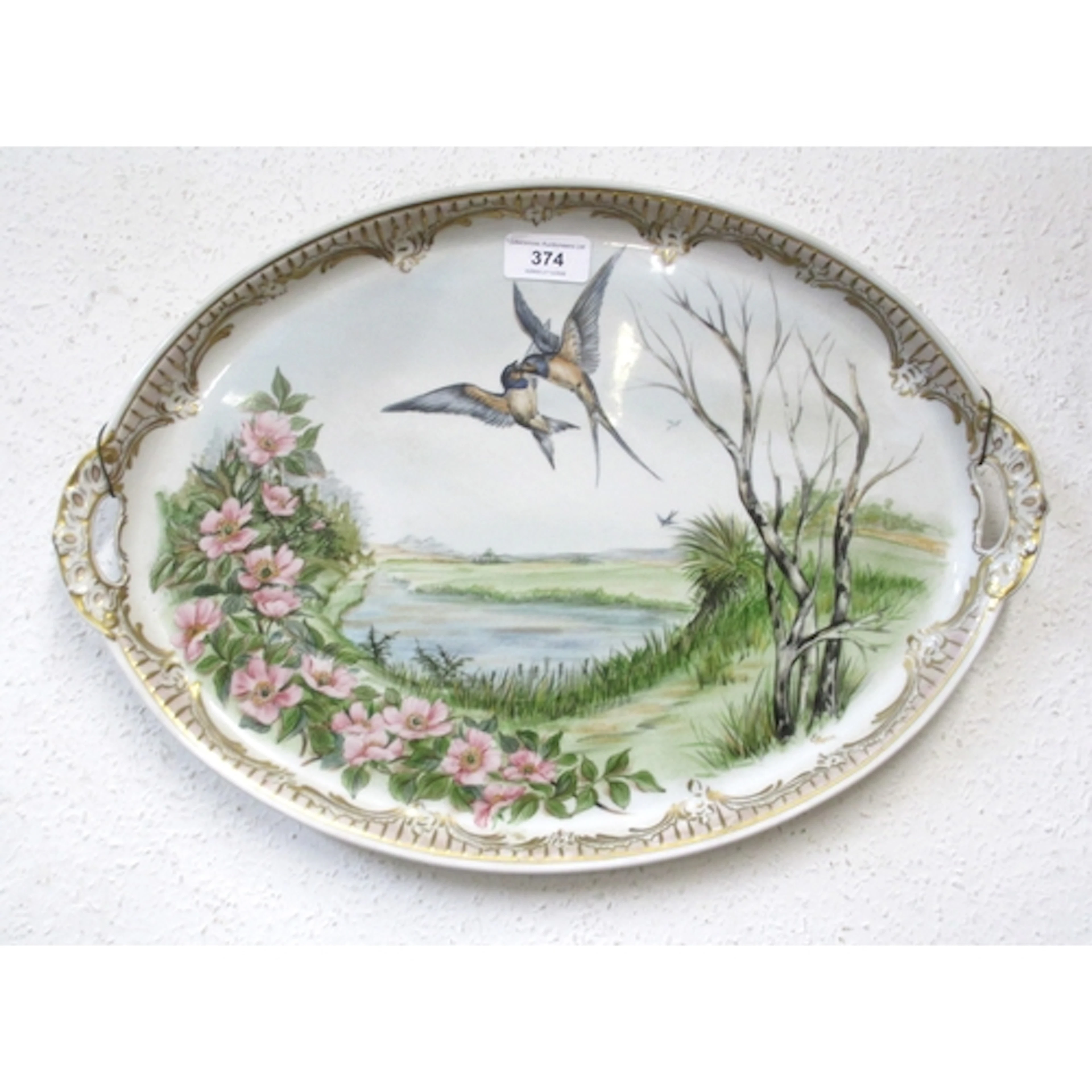 Oval Continental porcelain tray, painted with swallows in a ...