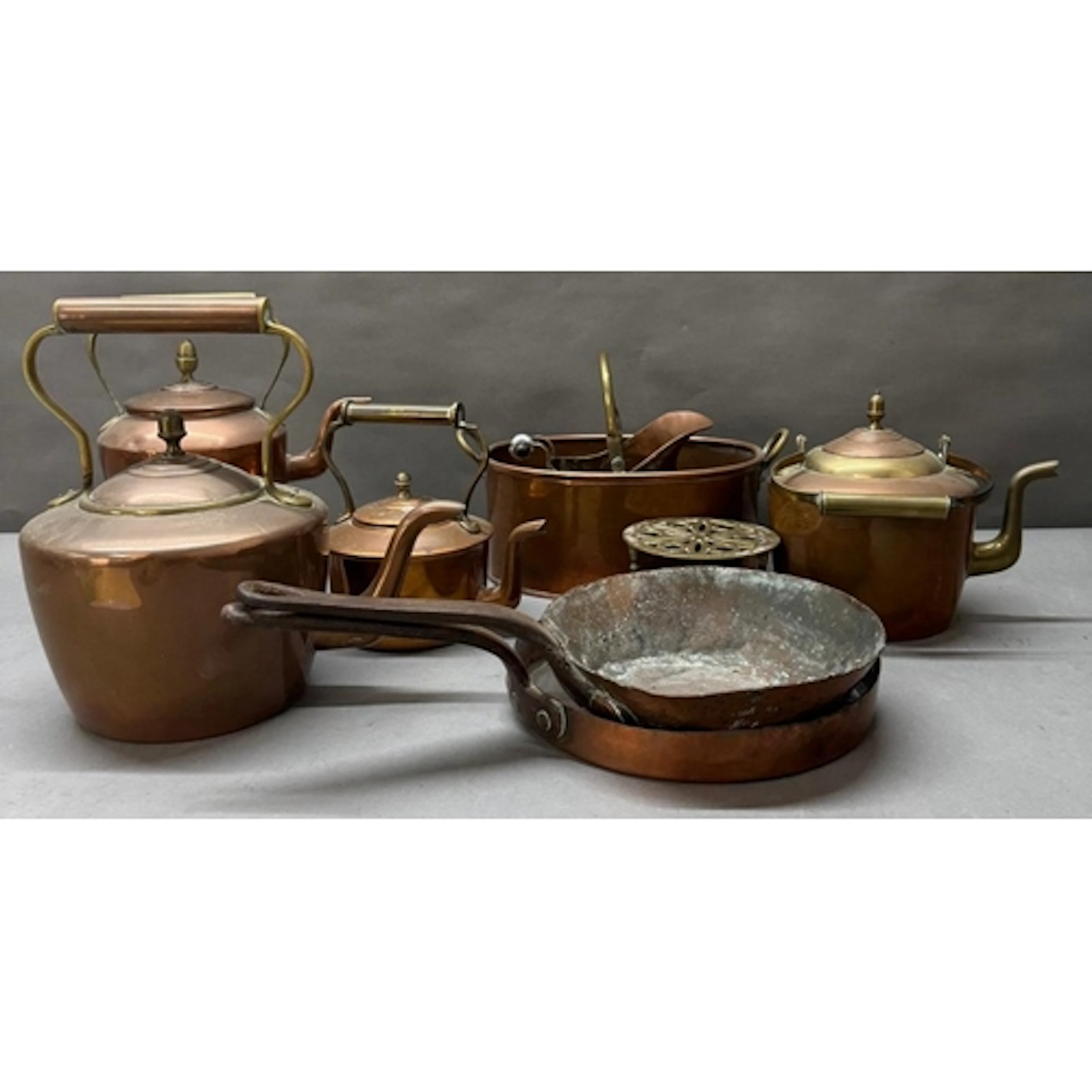 A selection of copper kettles and pans.