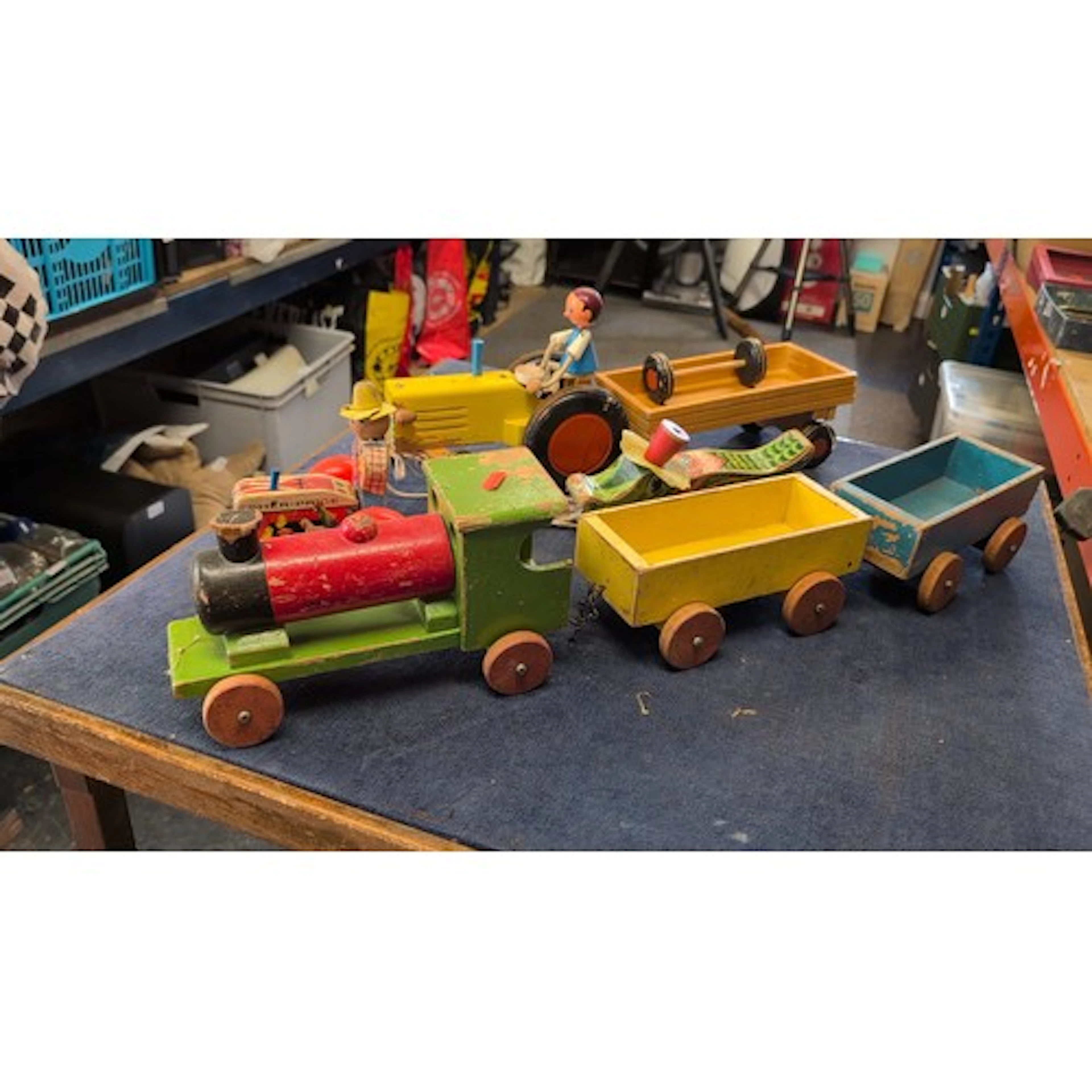 A group of vintage painted wooden pull-along toys, including...