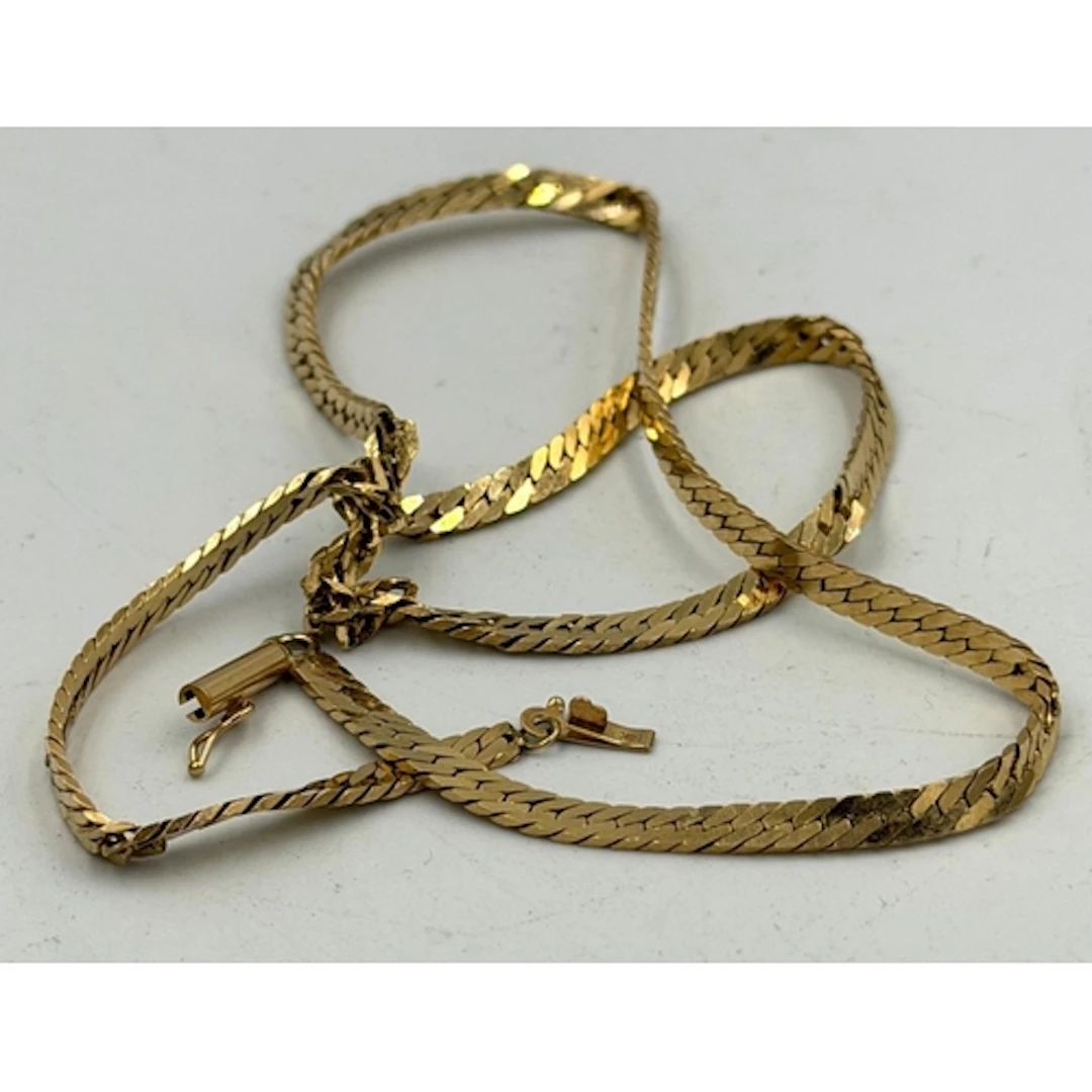 A 14ct gold AF necklace in a flat link herringbone style, ap...