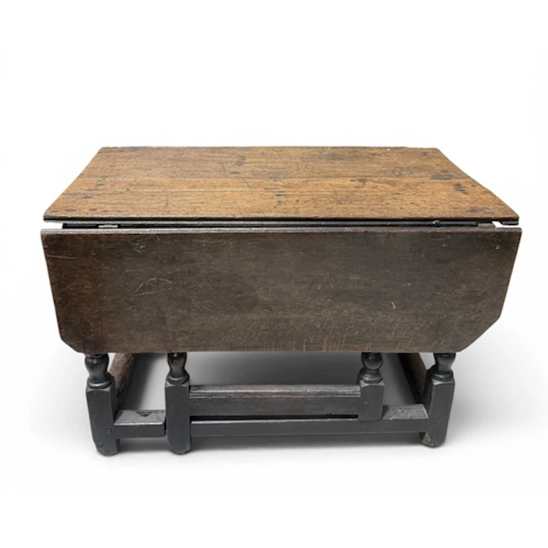 A 17TH CENTURY OAK GATELEG TABLE The rectangular top of plan...