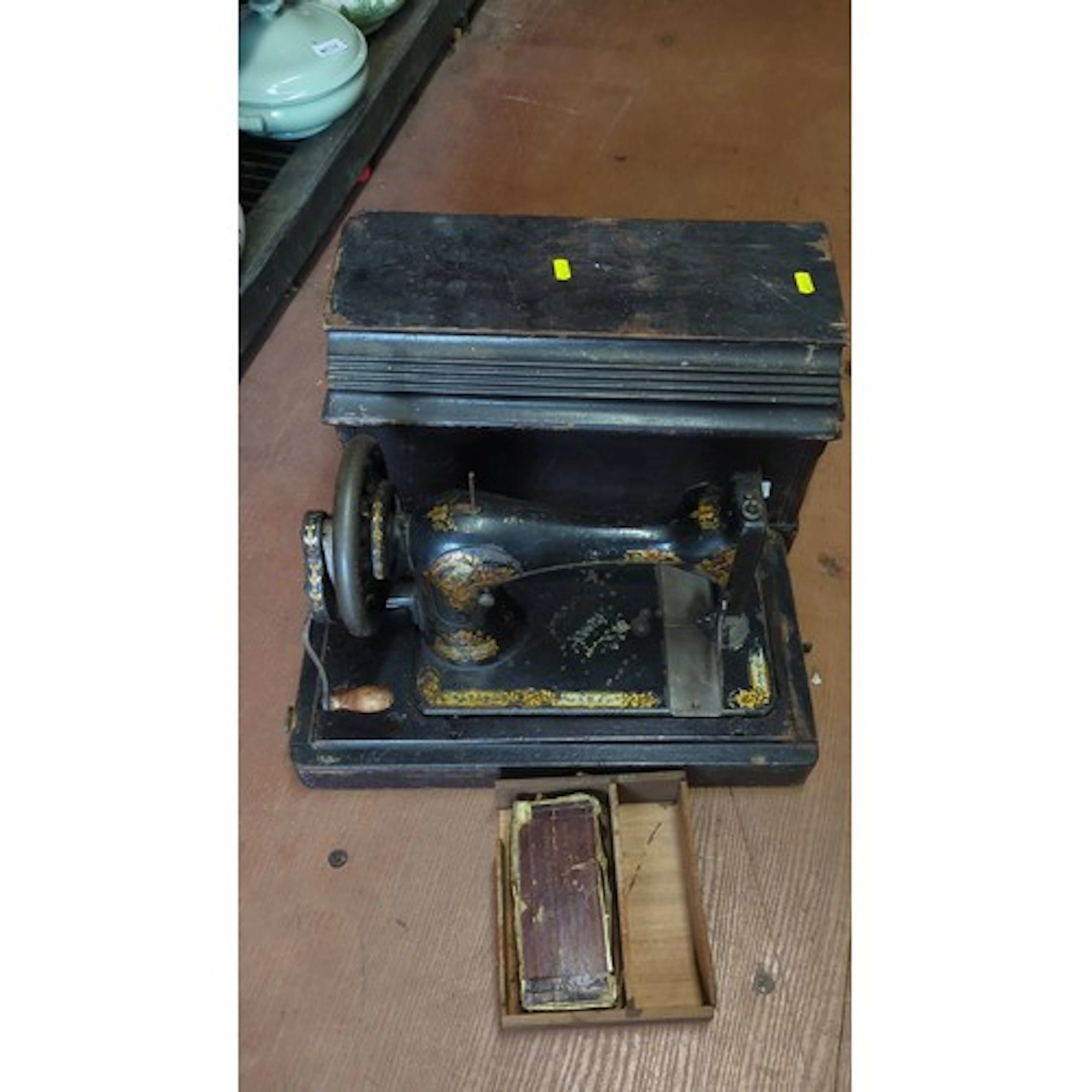 Singer hand-crank sewing machine, the black japanned iron bo...