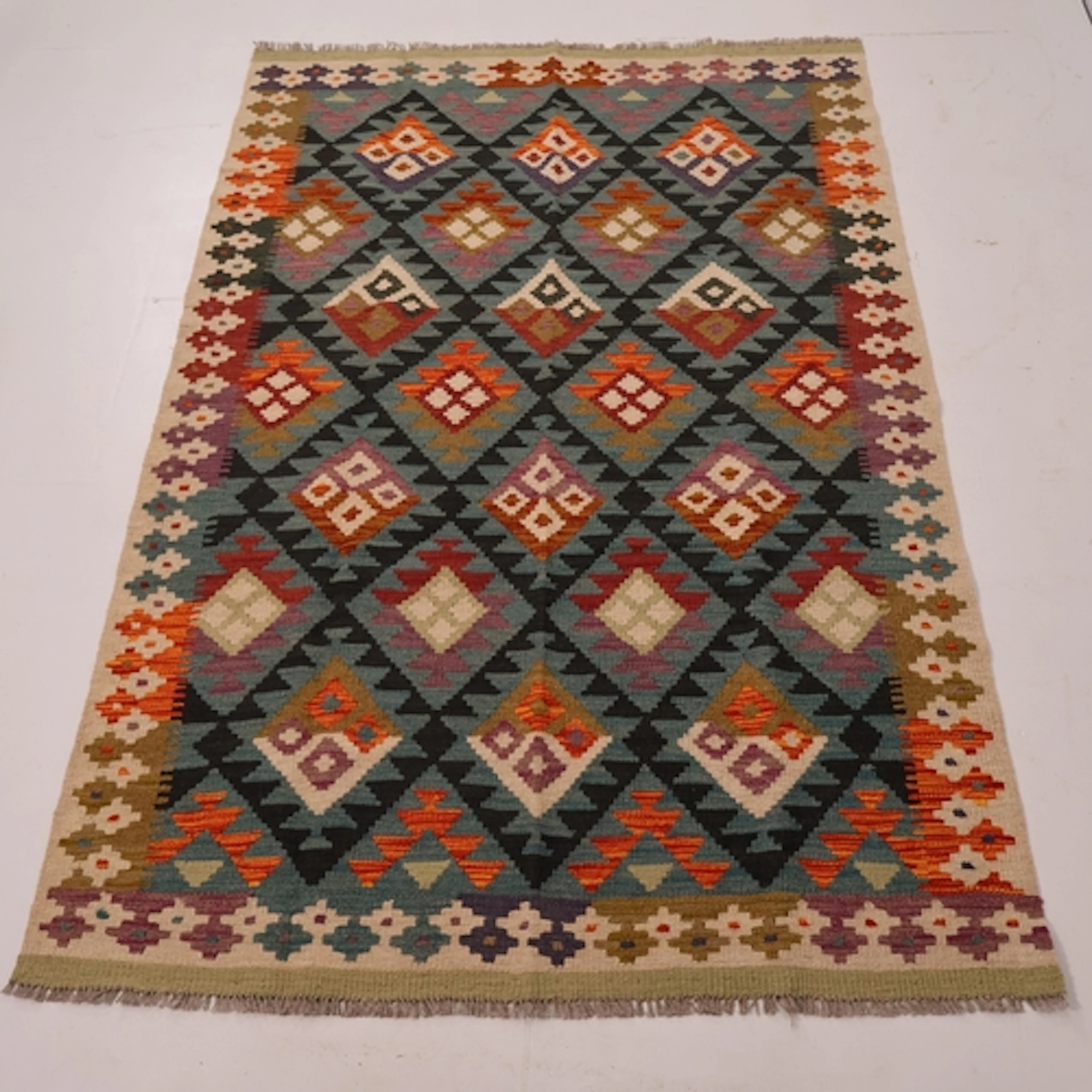 A large blue ground and green bordered maimana kilim rug, L2...