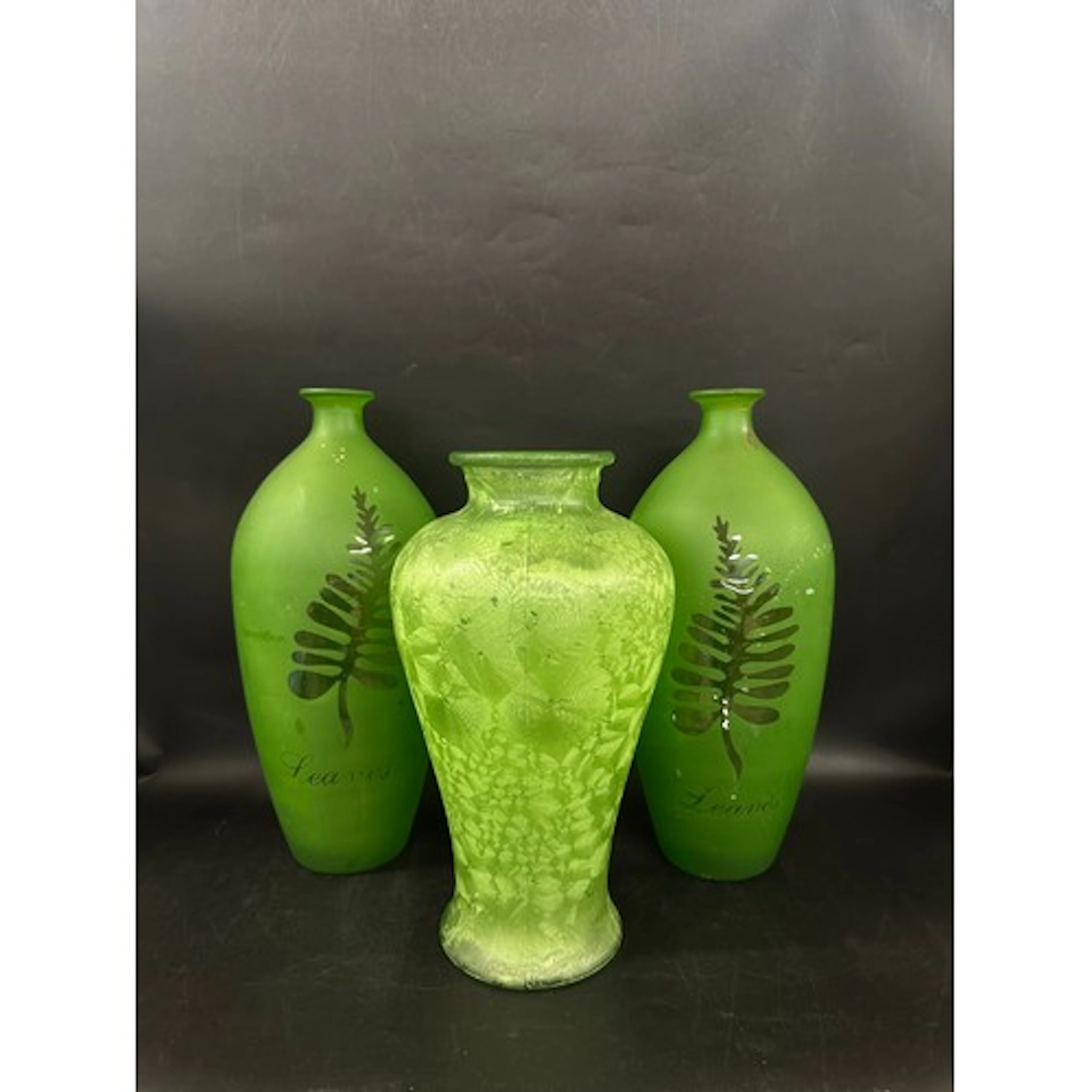 Three green pressed glass vases, 36cm h