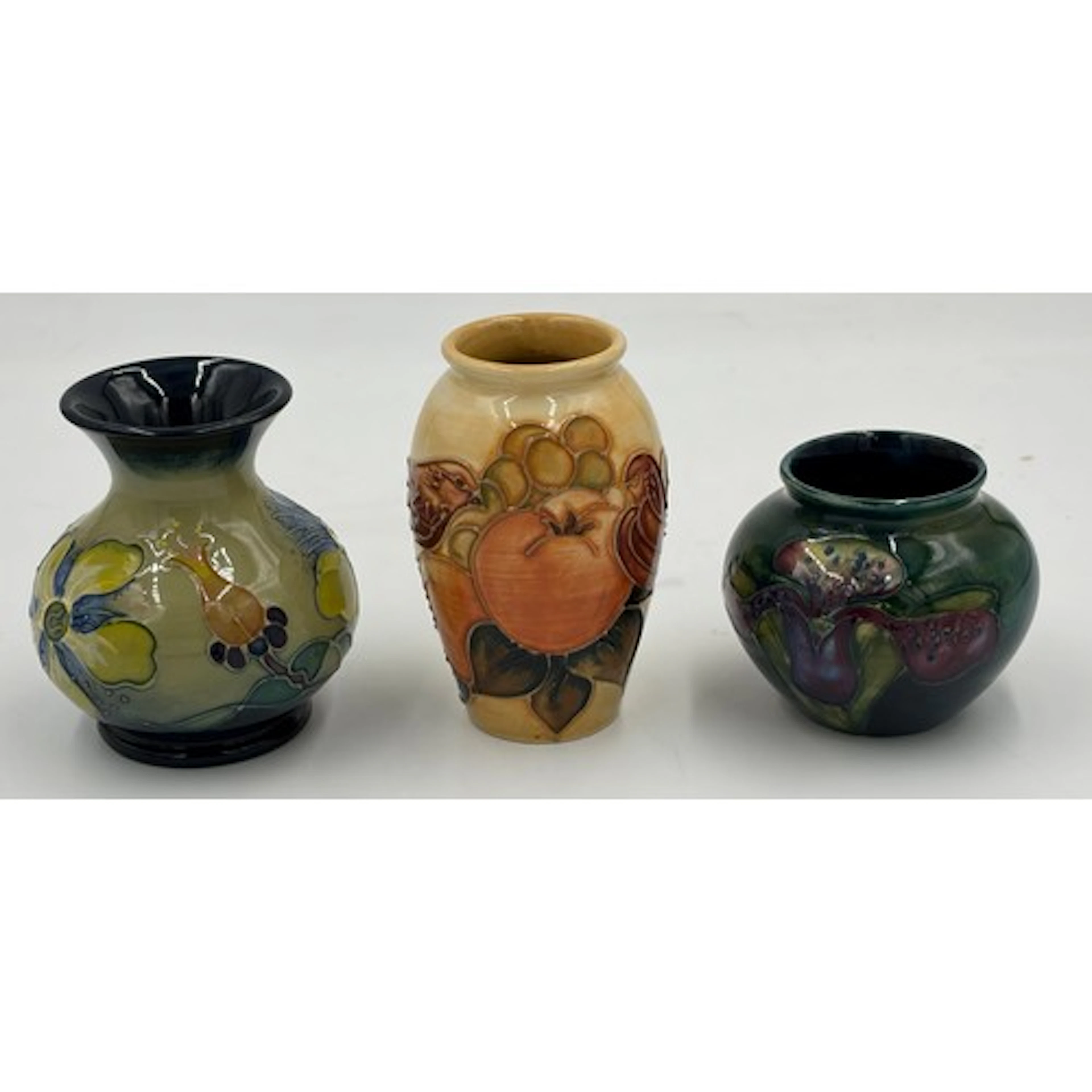 A collection of Moorcroft pottery to include a 'Hypericum' s...