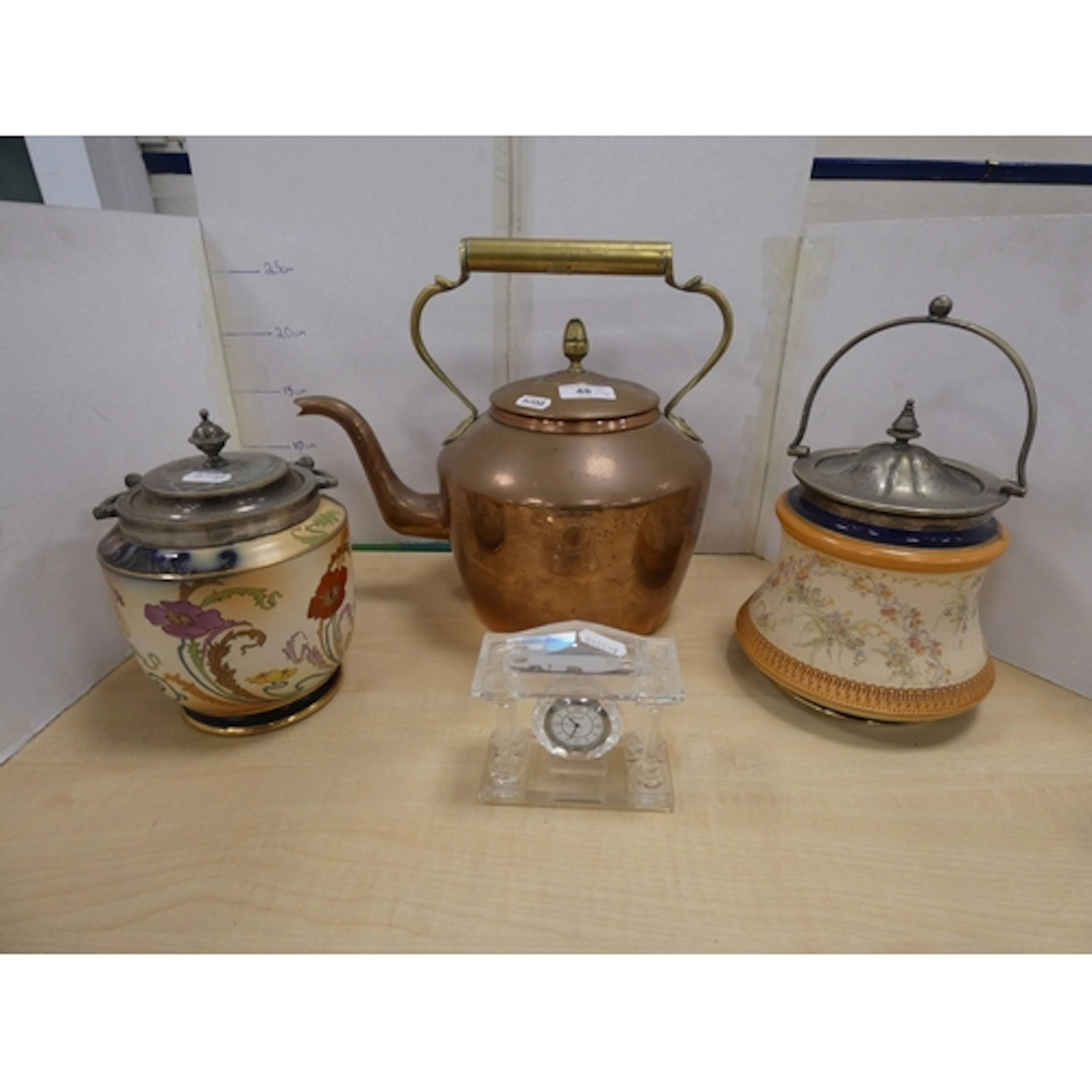 Brass and copper kettle, two ceramic swing-handle biscuit ba...