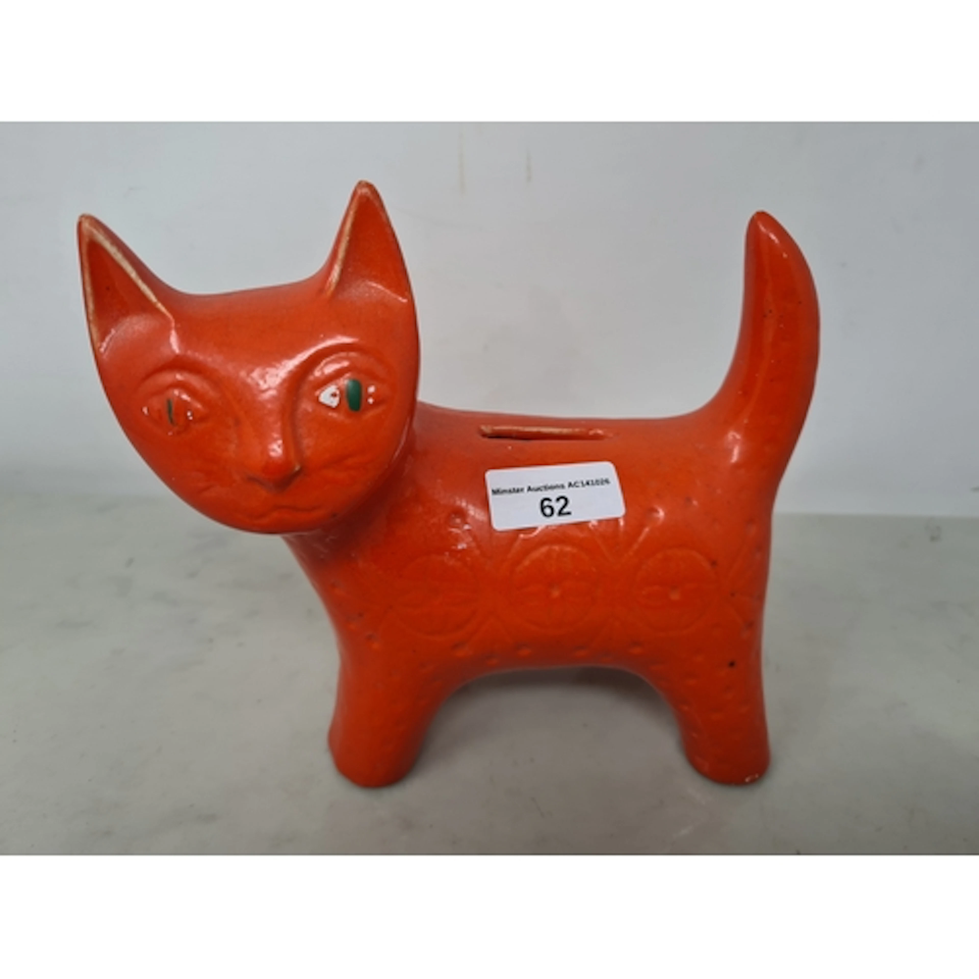 A Jema Holland pottery Cat Money Box with orange glaze havin...