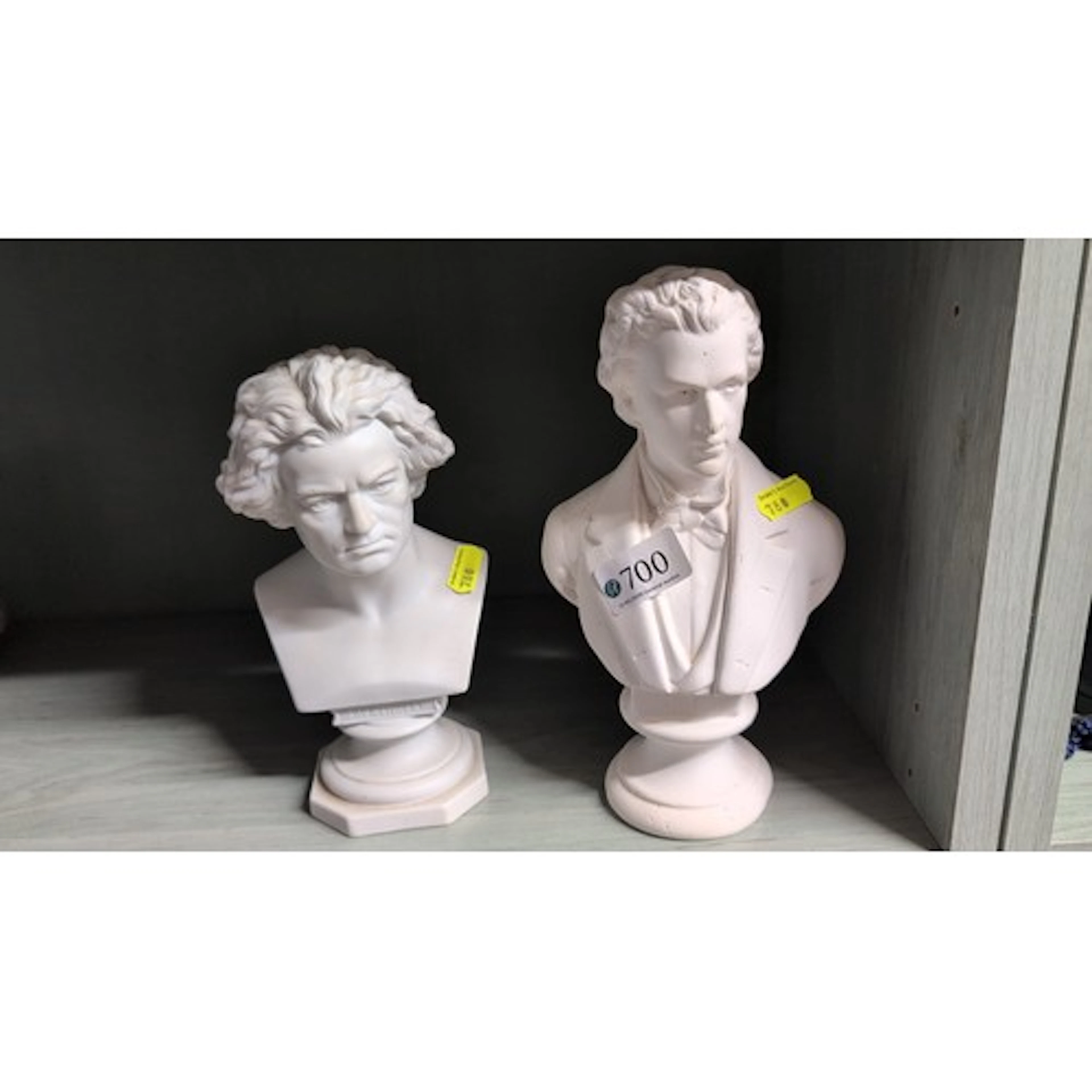 A pair of white composition portrait busts, after classical ...