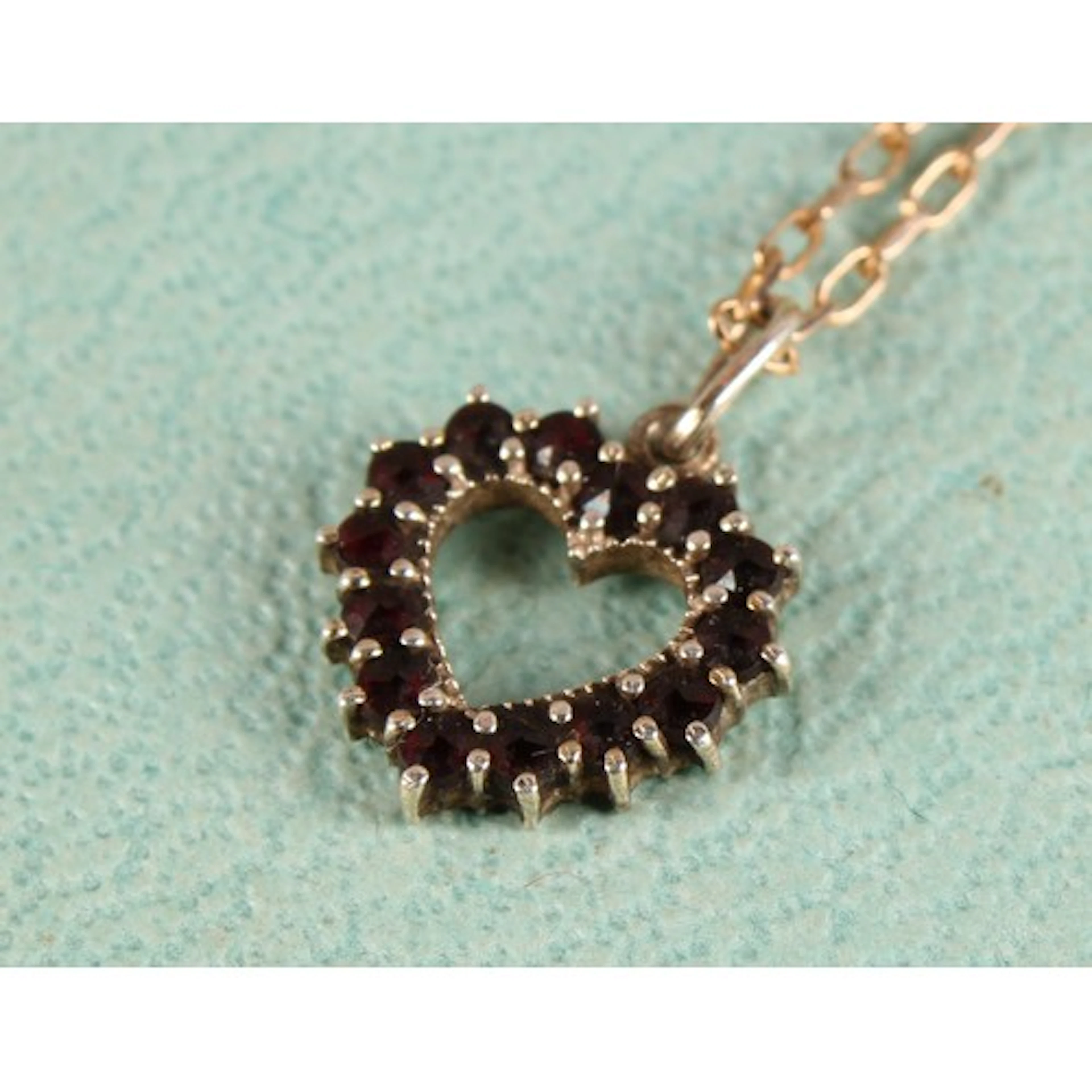 A 9ct gold and black garnet necklace, heart-shaped pendant, ...