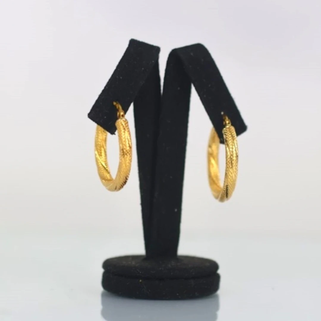 A pair of contemporary yellow metal hoops, possibly Italian,...
