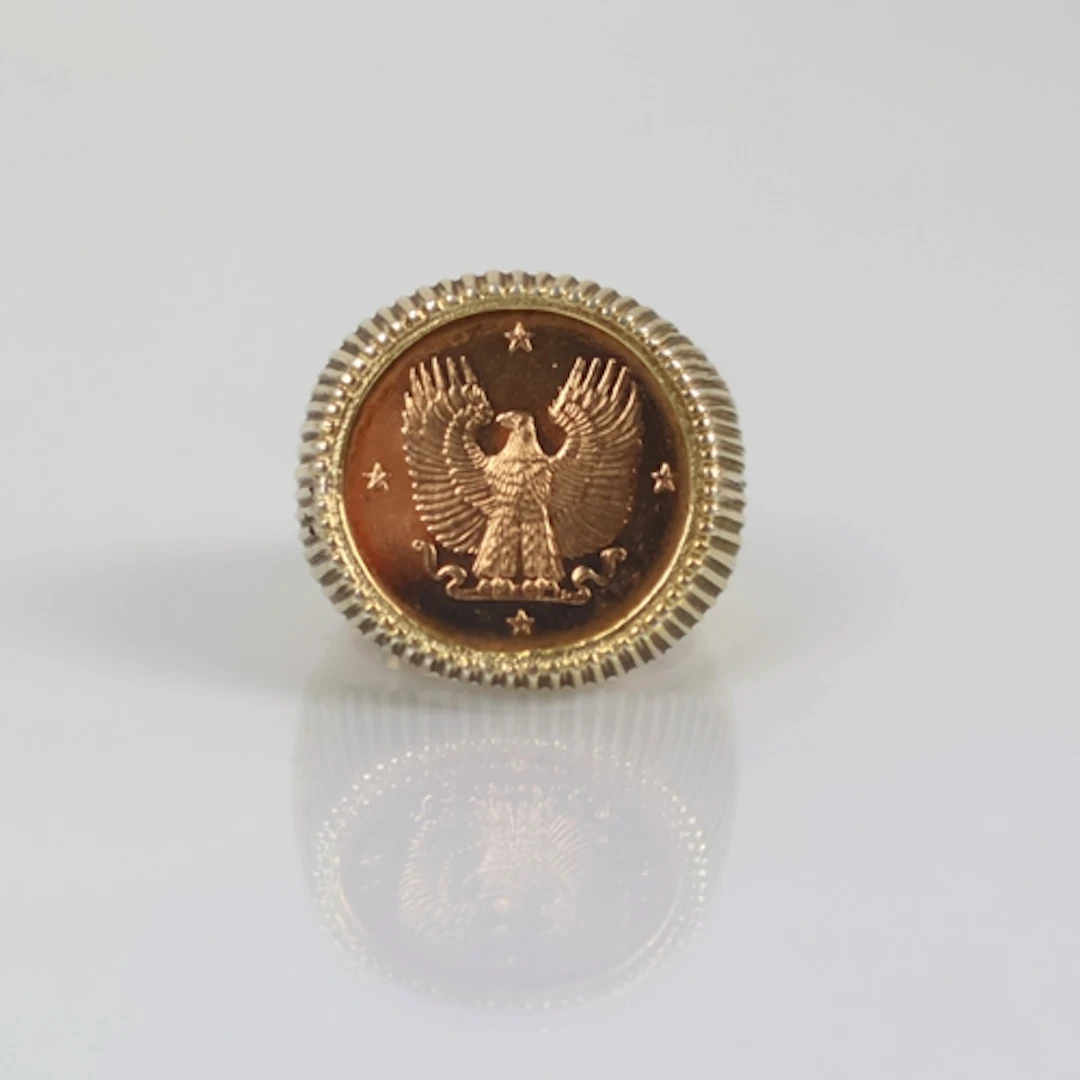 A late 20th century coin set ring, the gold coloured coin wi...