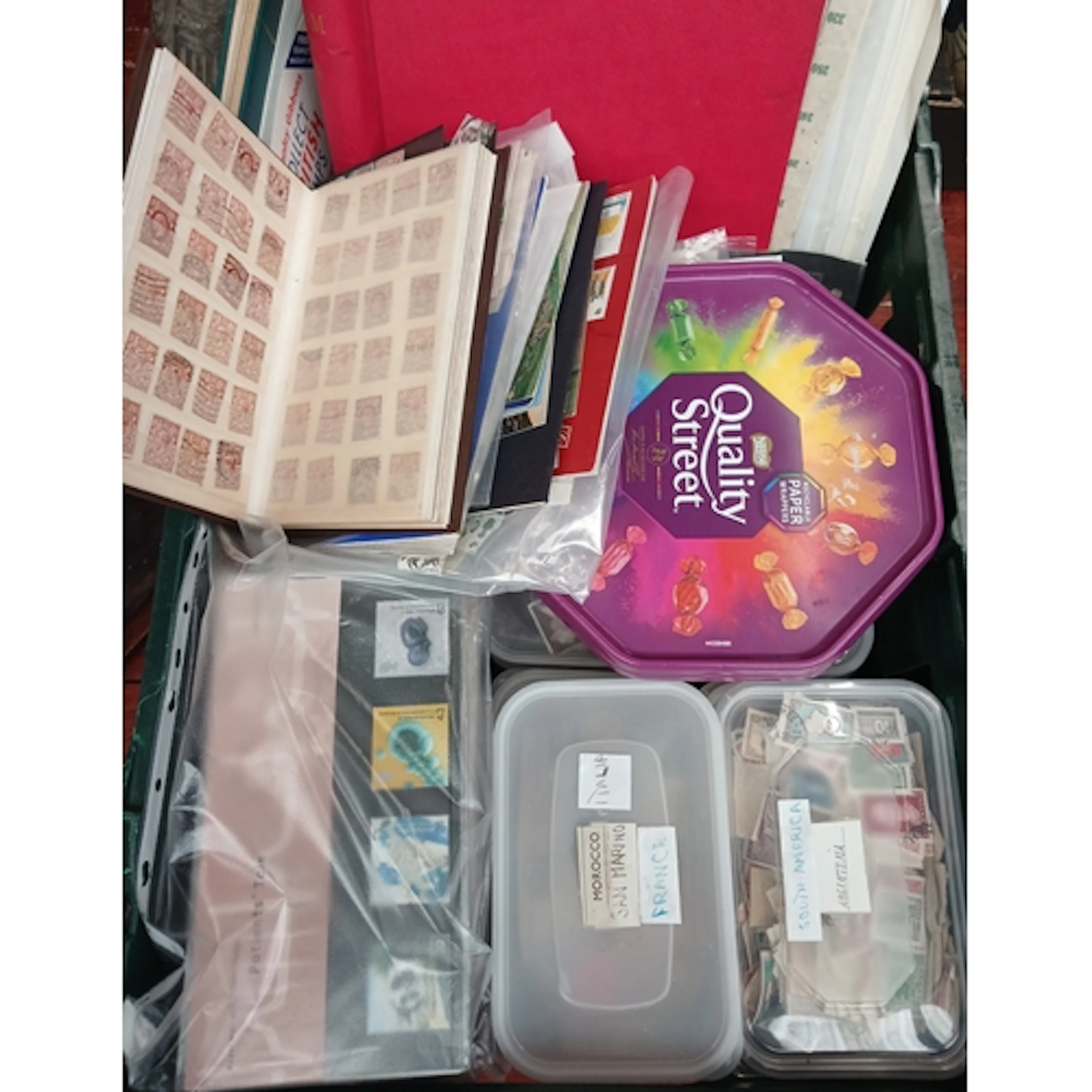 A box of assorted world stamps to include albums, presentati...