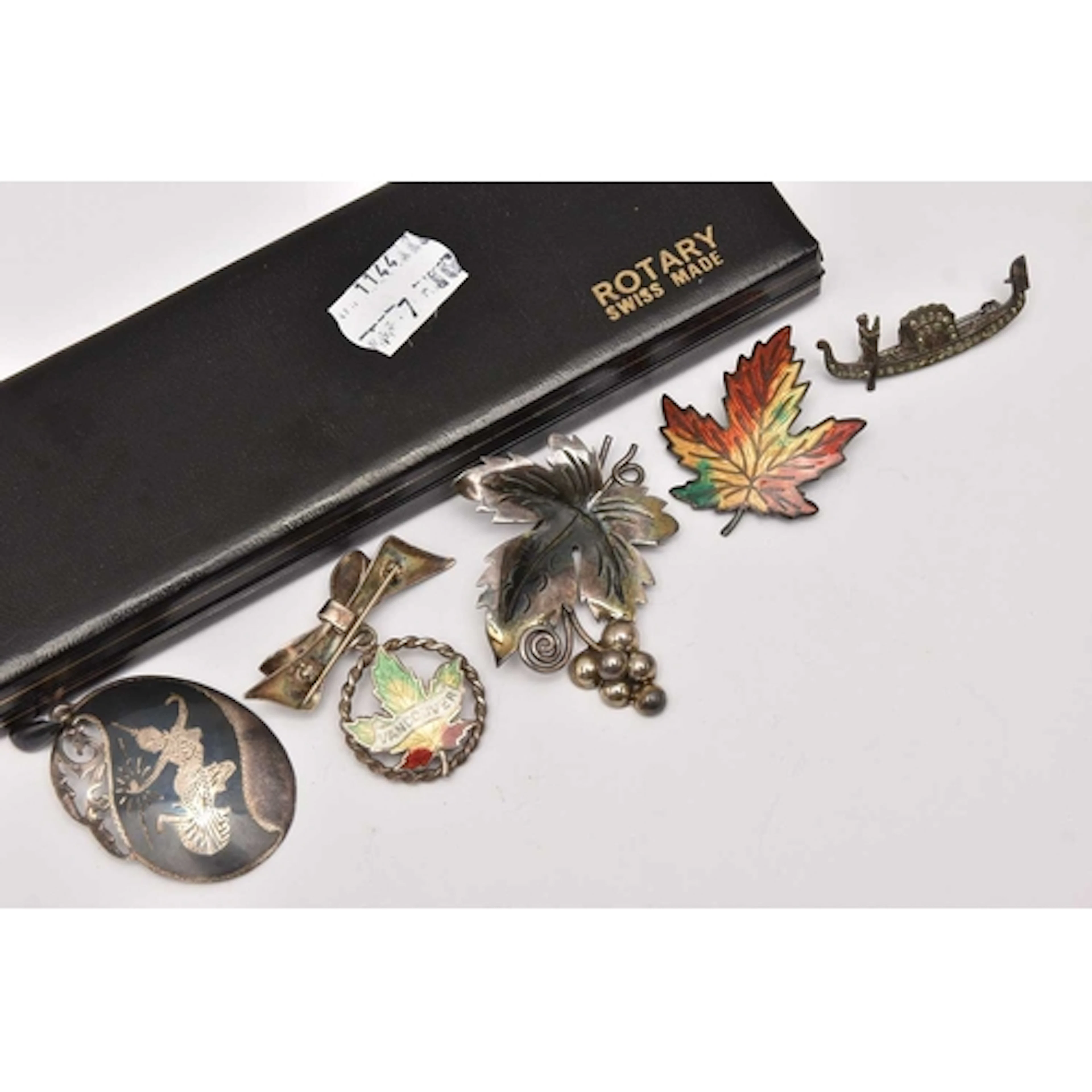 FOUR WHITE METAL BROOCHES AND A PENDANT, to include two cana...