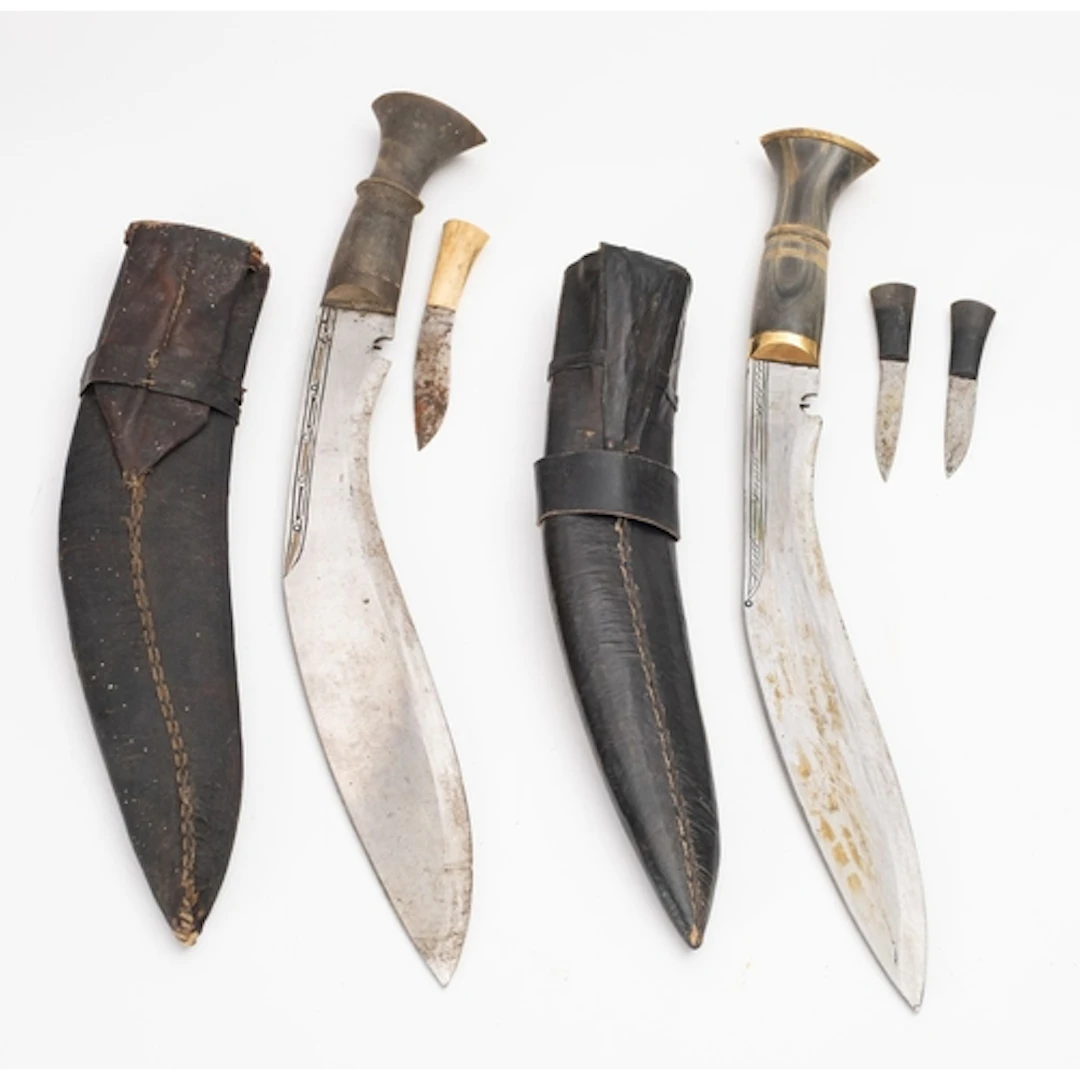 Two 20th Century Kukri knives. Both with curved single edged...