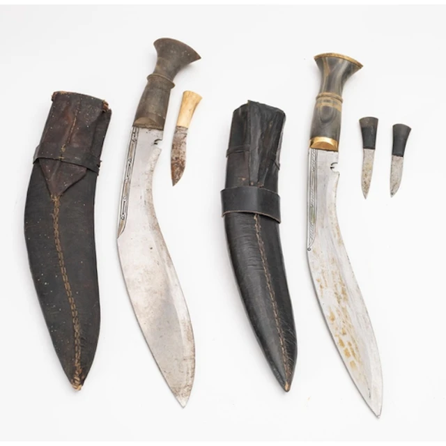 Two 20th Century Kukri knives. Both with curved single edged...