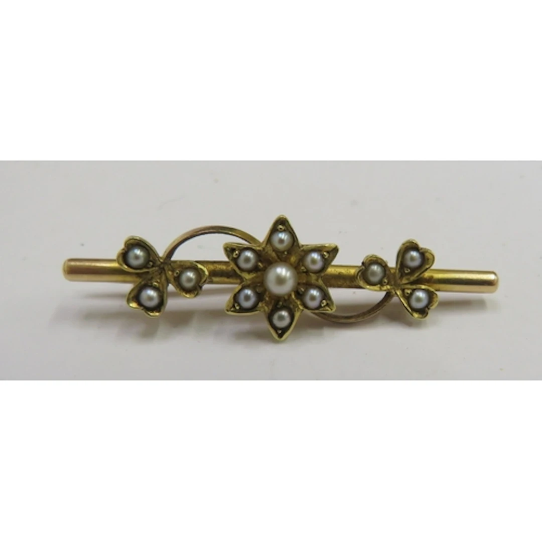 Antique Yellow Metal (tests as 9ct) bar brooch, central flow...