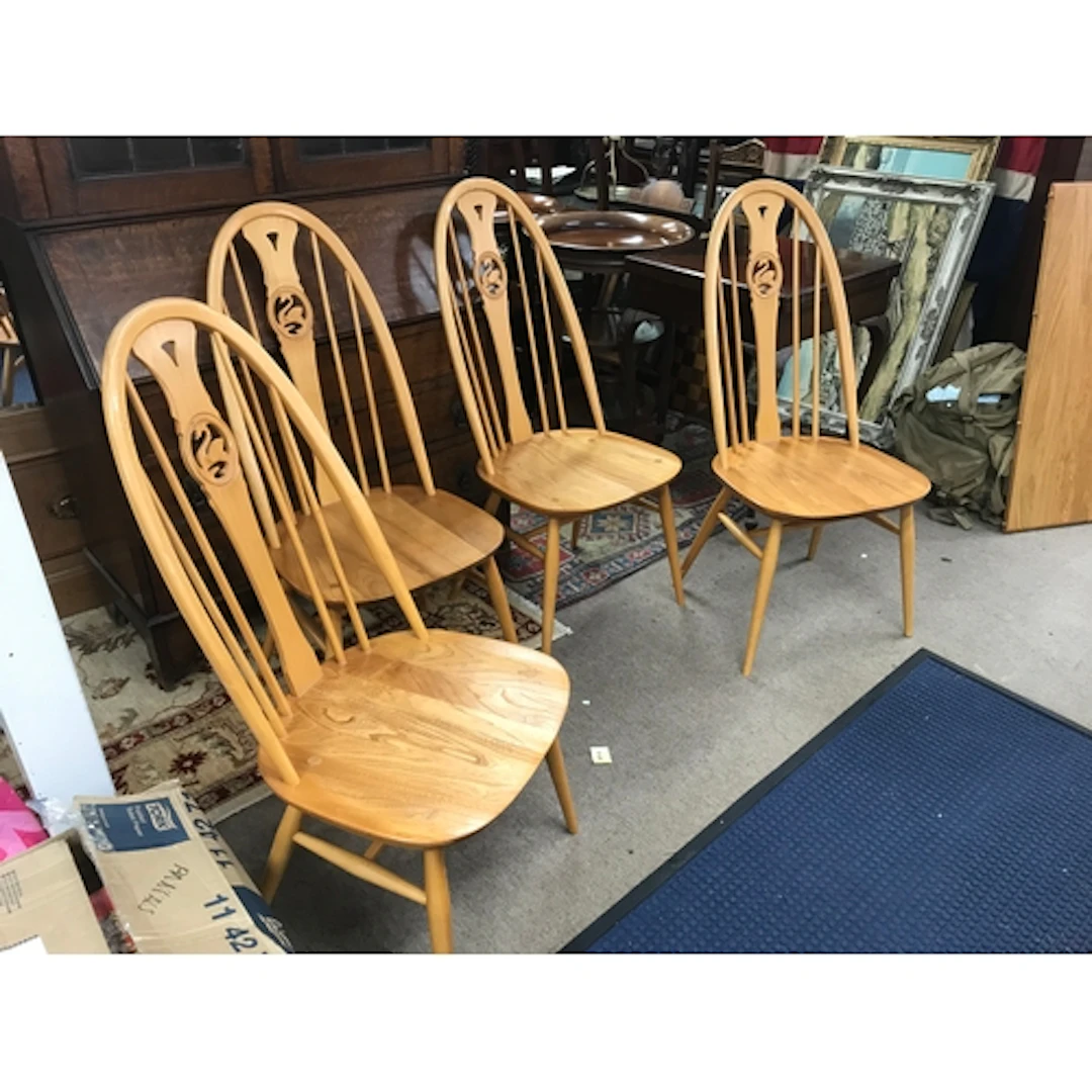 An Ercol table and four chairs, 111cm wide. Chairs 100cm tal...