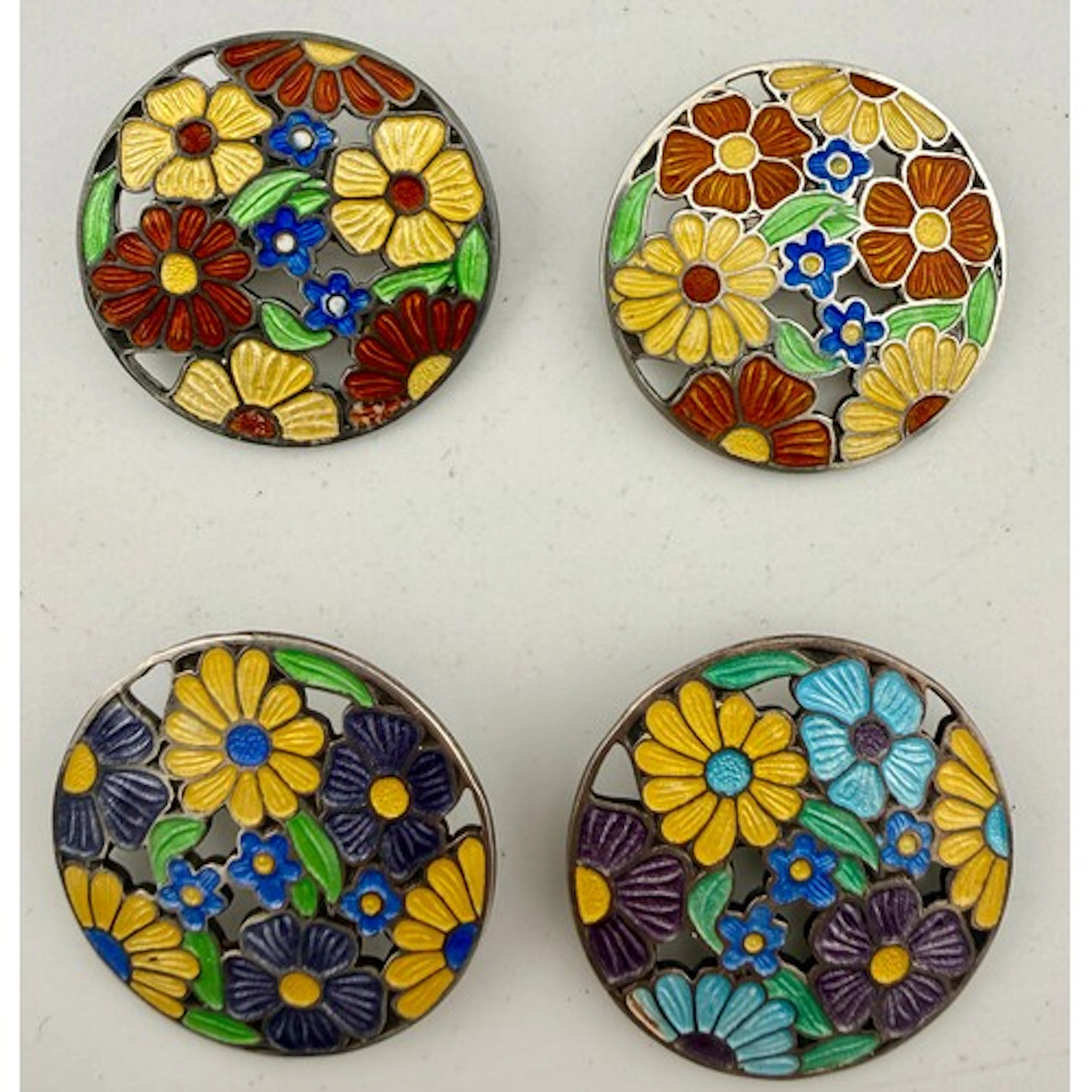 Four hallmarked silver and enamel circular brooches. Birming...