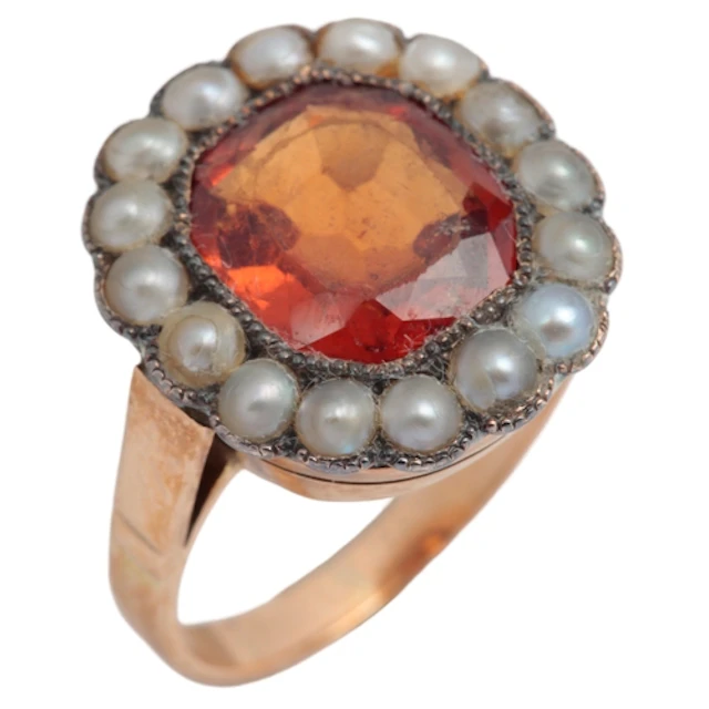 A hessonite garnet and pearl ring, mid 20th century, set wit...