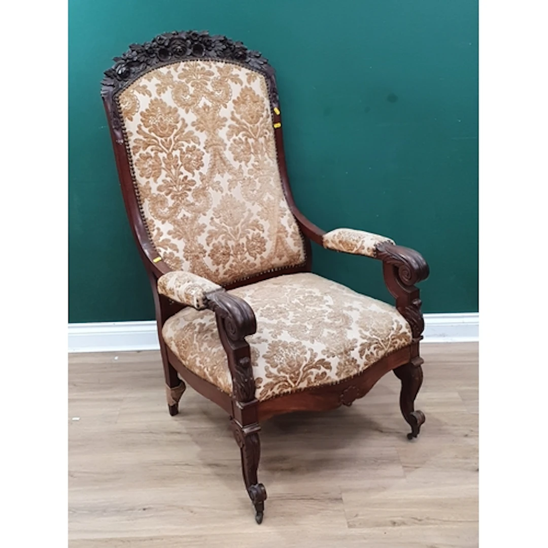 A 19th century carved mahogany open Armchair raised on scrol...