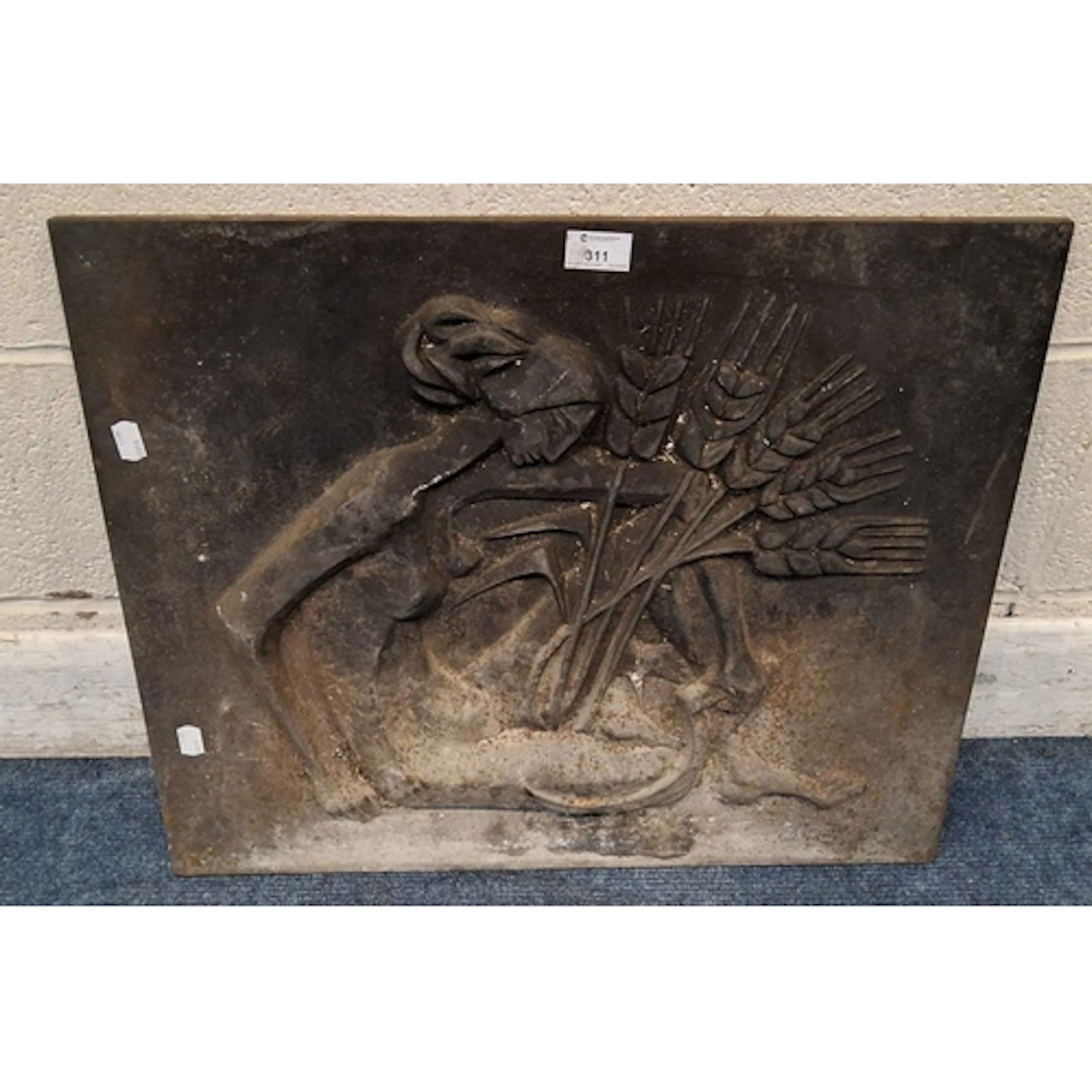 A CAST IRON FIREBACK, depicting a lady holding wheat and a s...