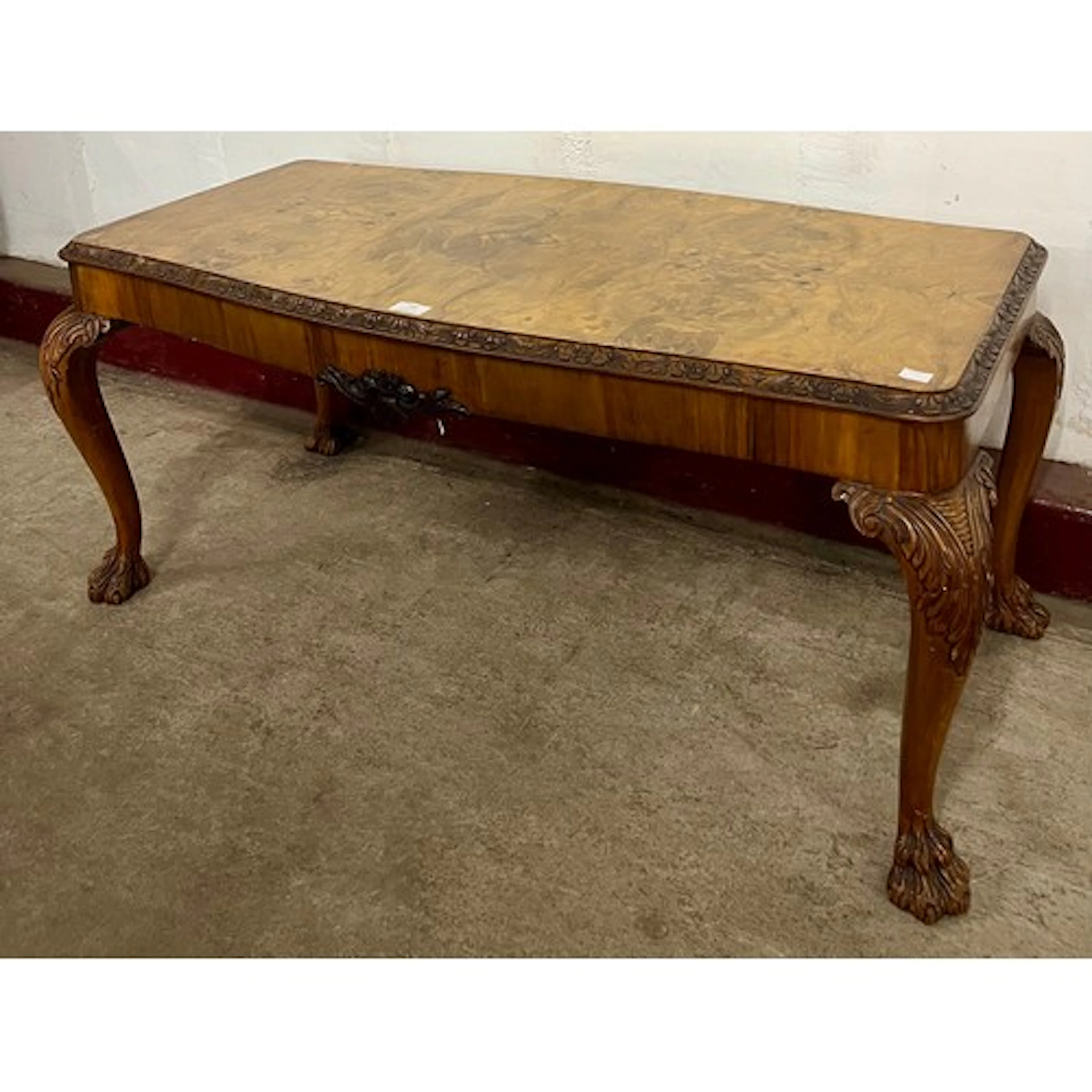 A Queen Anne style figured walnut rectangular coffee table