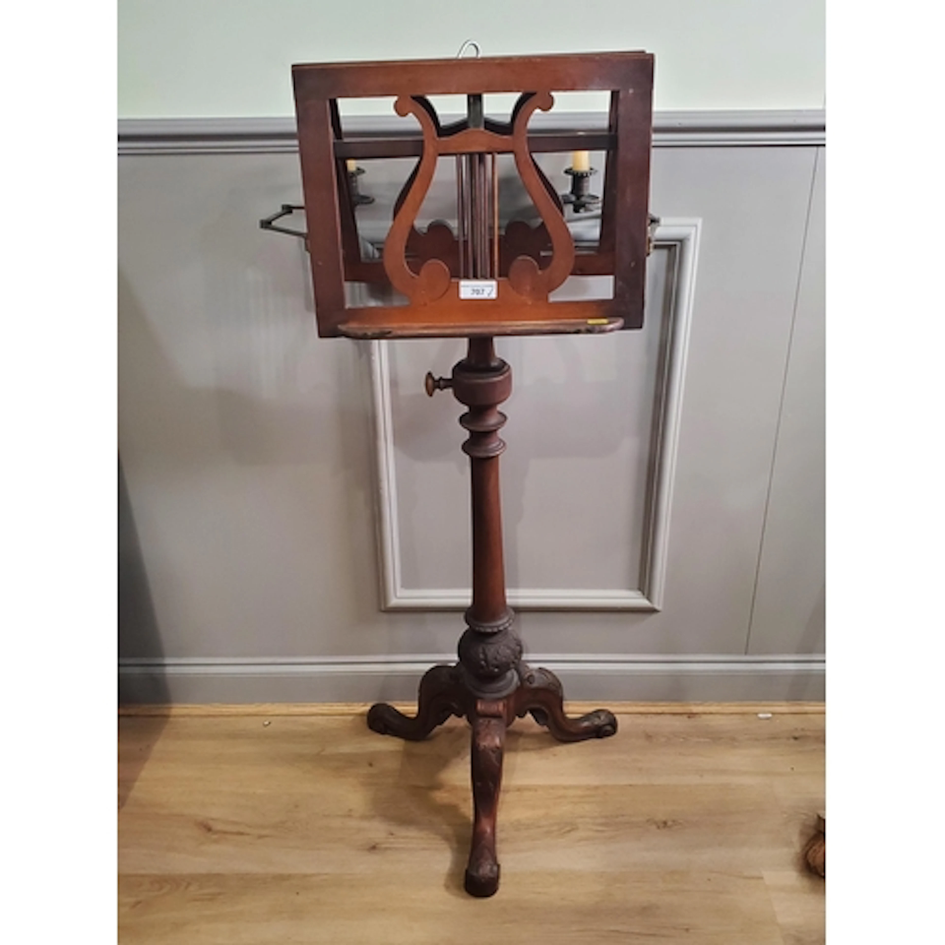 An antique mahogany music Stand with fold out candle holders...