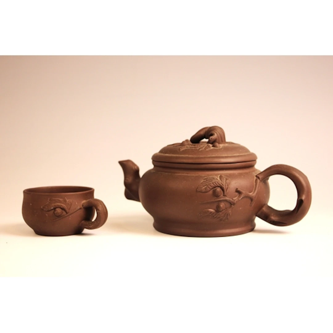 A Chinese Yixing pottery teapot, early 20th century, with mo...