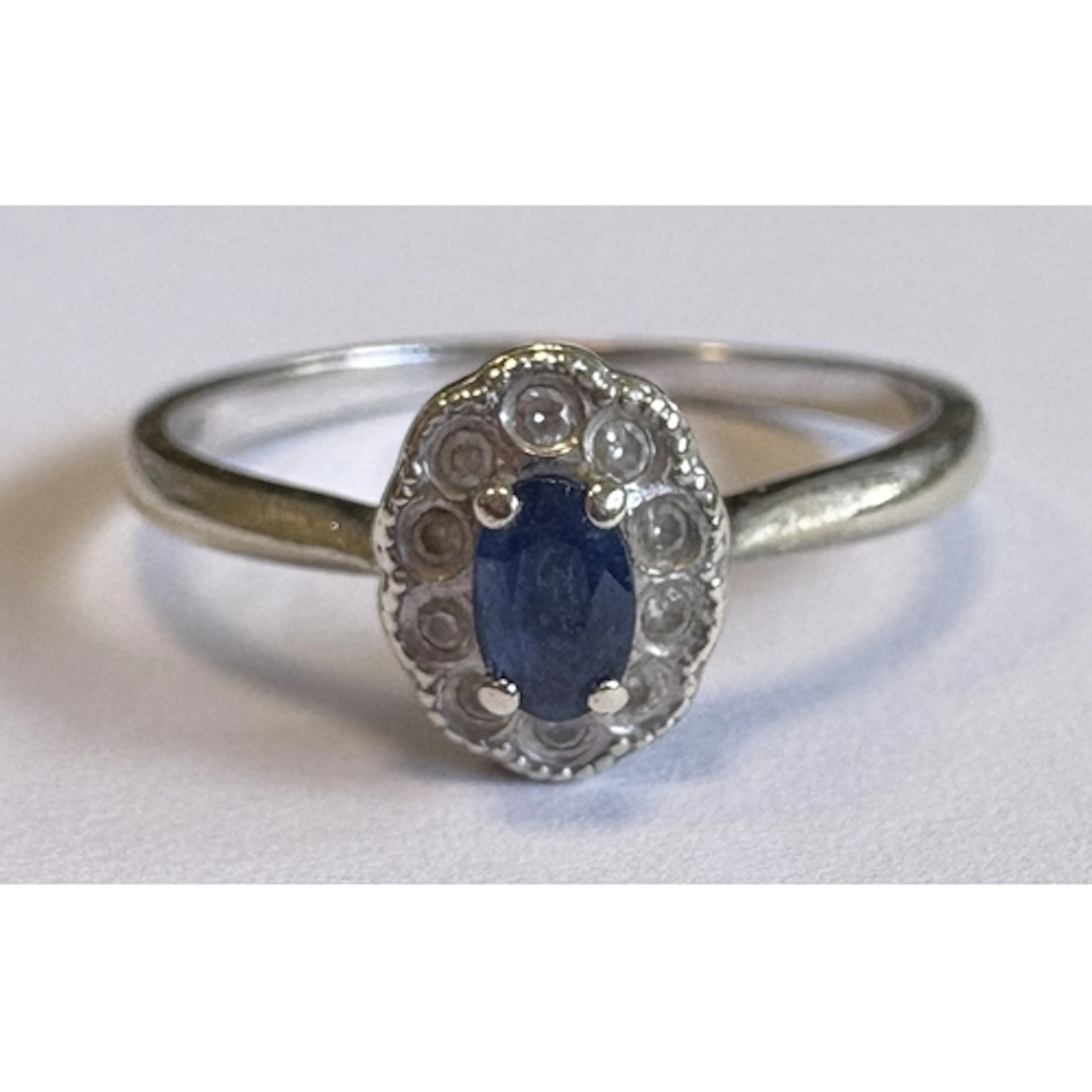 A small sapphire and diamond cluster ring in white gold sett...