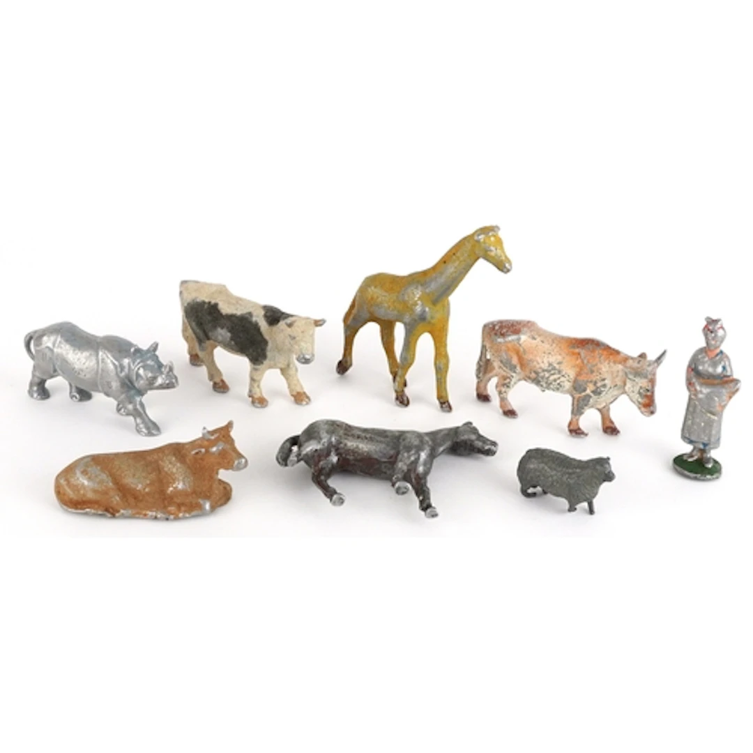 Small collection of metal animal figurines including cows, g...