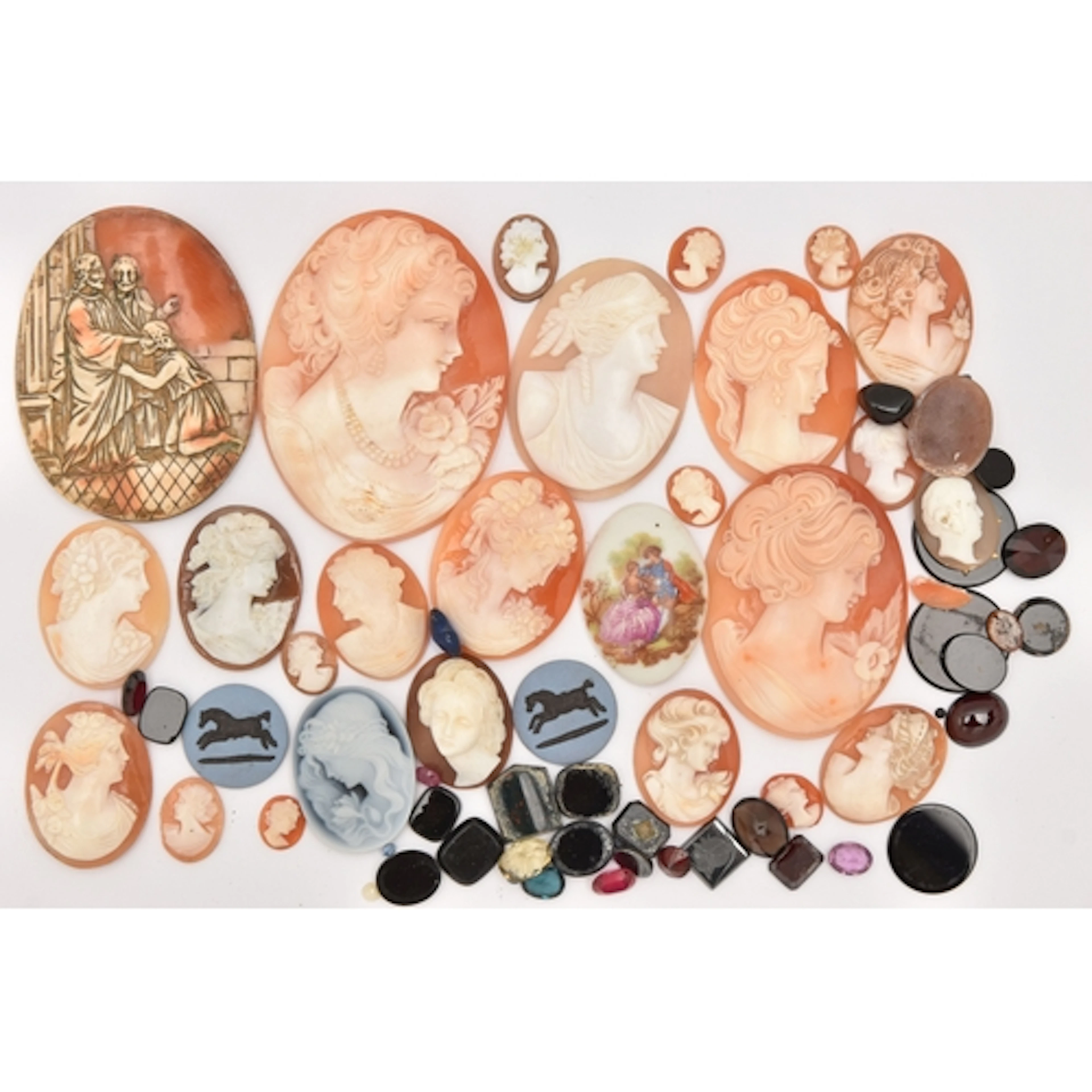 A BAG OF LOOSE CAMEOS AND GEMSTONES, carved shell cameos of ...