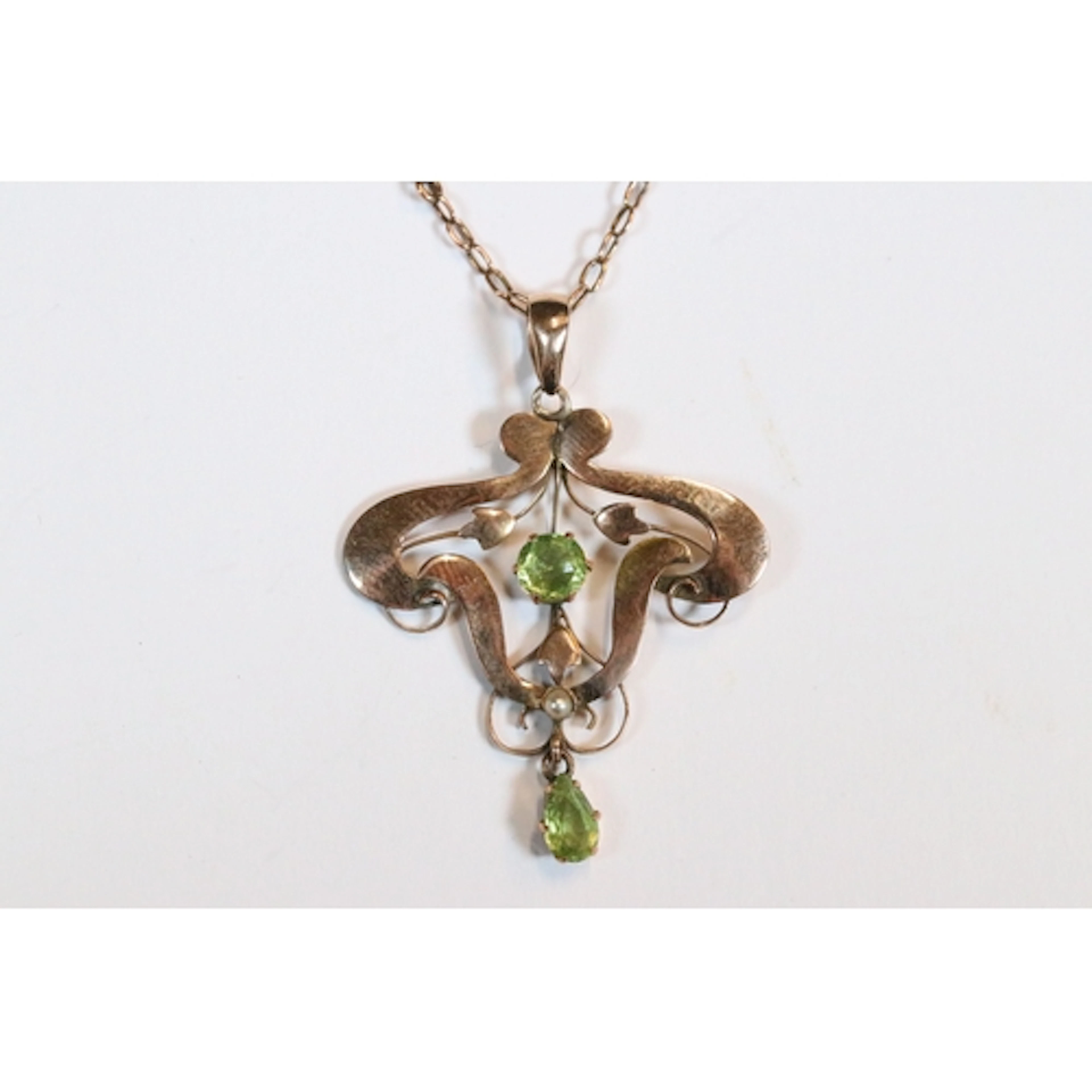 An early 20th century 9ct gold Art Nouveau drop pendant, set...
