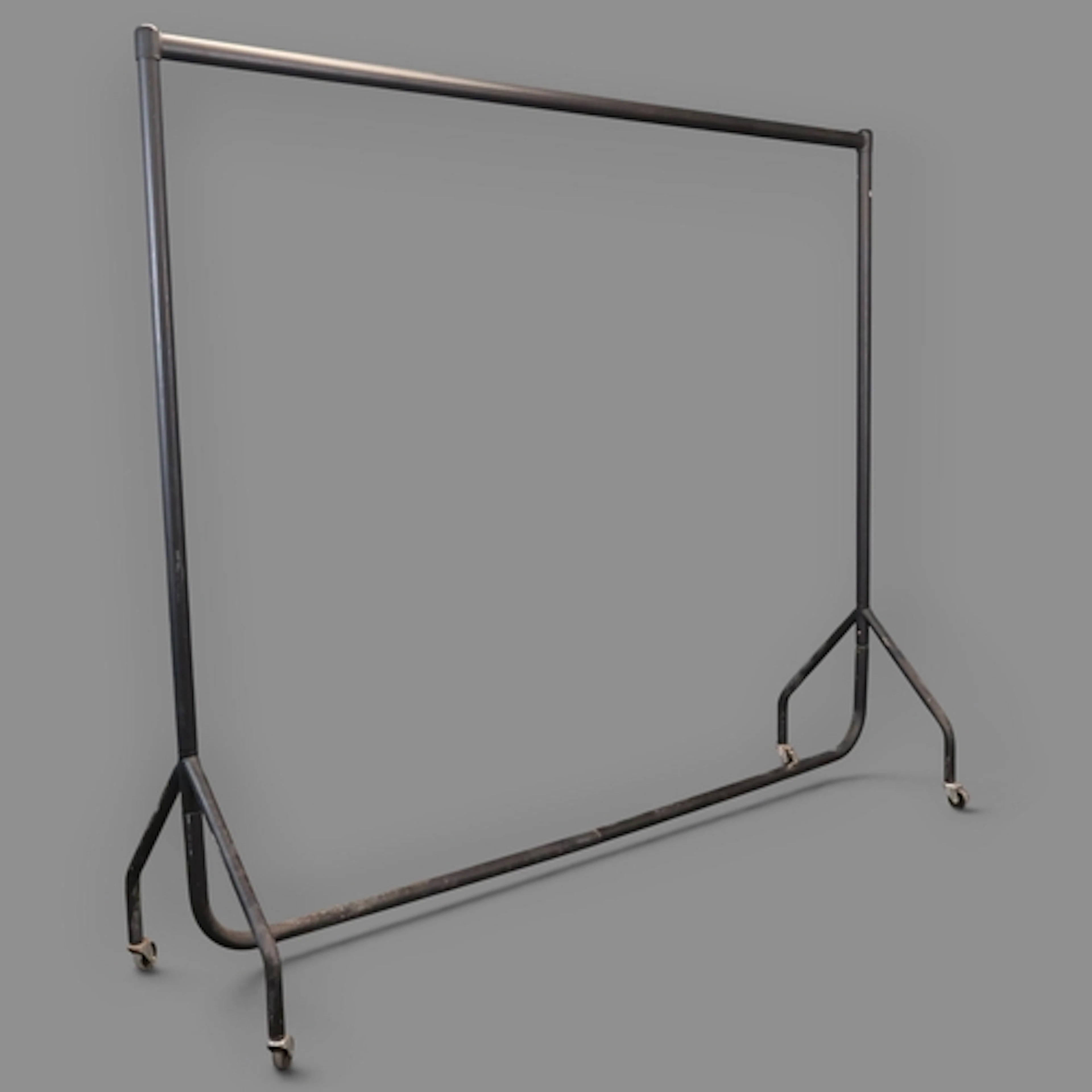A vintage metal shop clothes rail. W183cm, H155cm, D53cm.