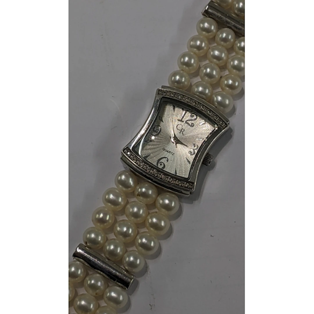 A CR ladies silver wrist watch, having an engine turned dial...