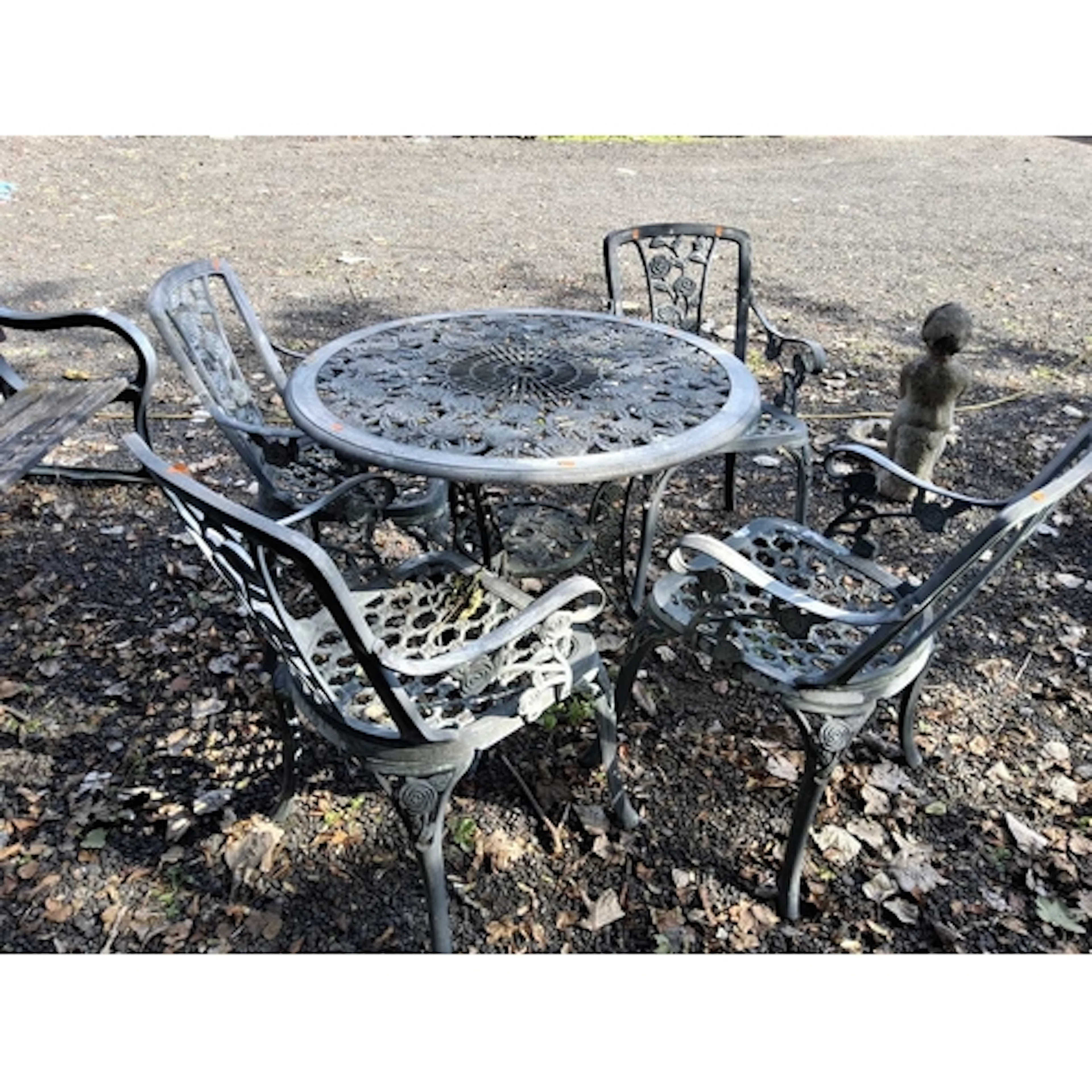 A CAST ALUMINIUM GARDEN TABLE AND FOUR SIMILAR CHAIRS with f...