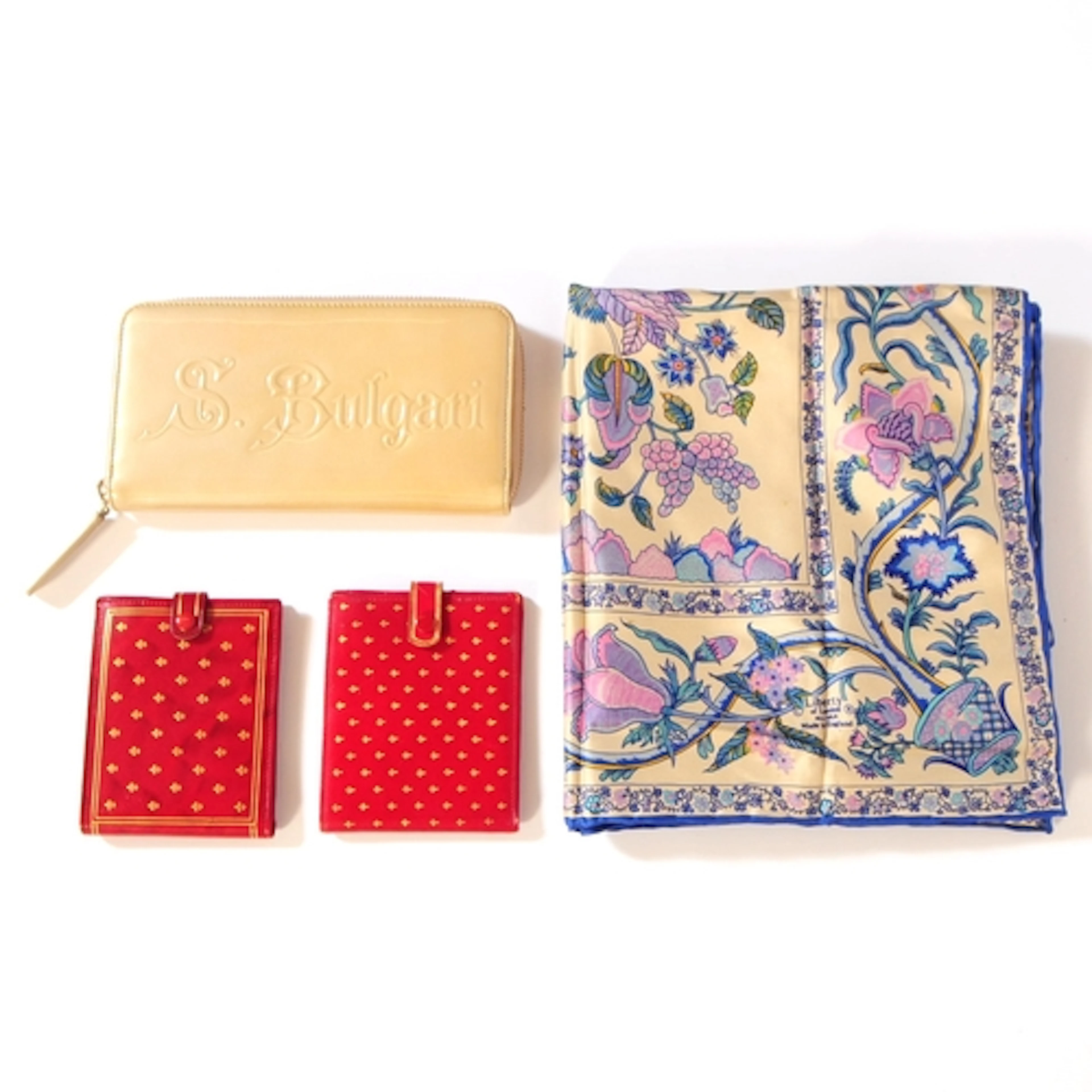 A collection of leather wallets and a Liberty London scarf. ...