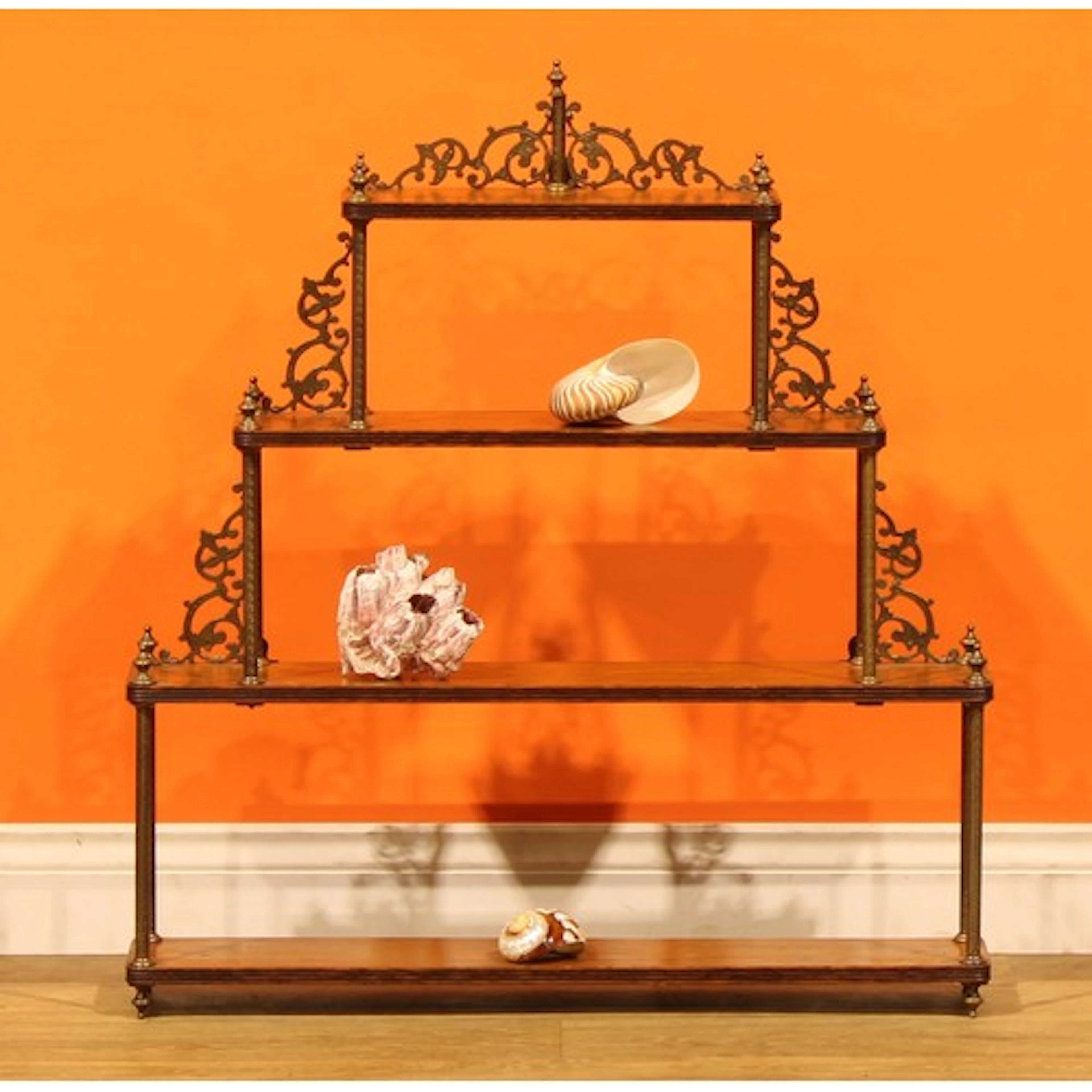 An Arts & Crafts period oak and brass collector’s wall shelf...