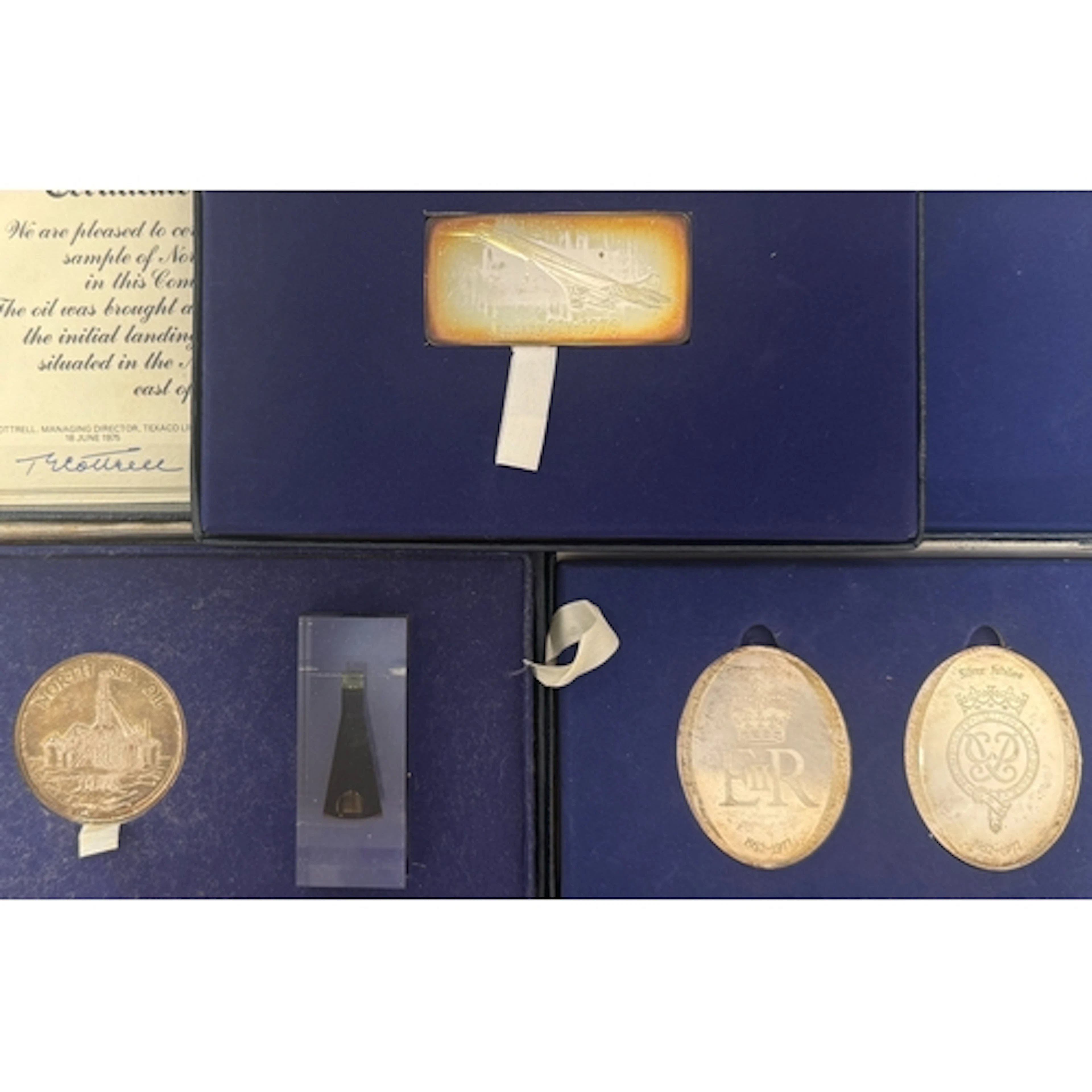 A group of four sterling silver commemorative ingots and med...