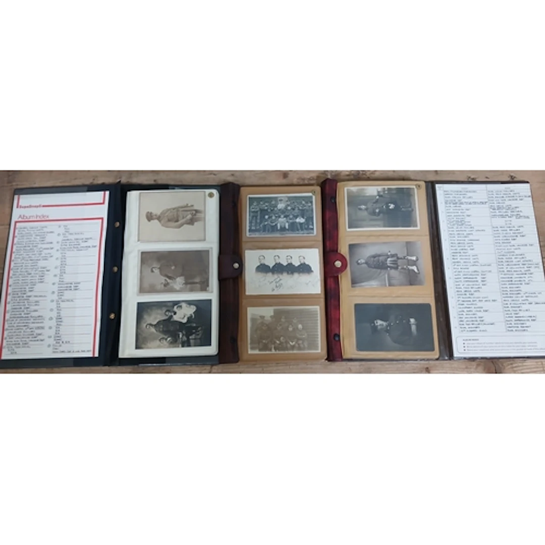A group of three albums containing military portrait postcar...