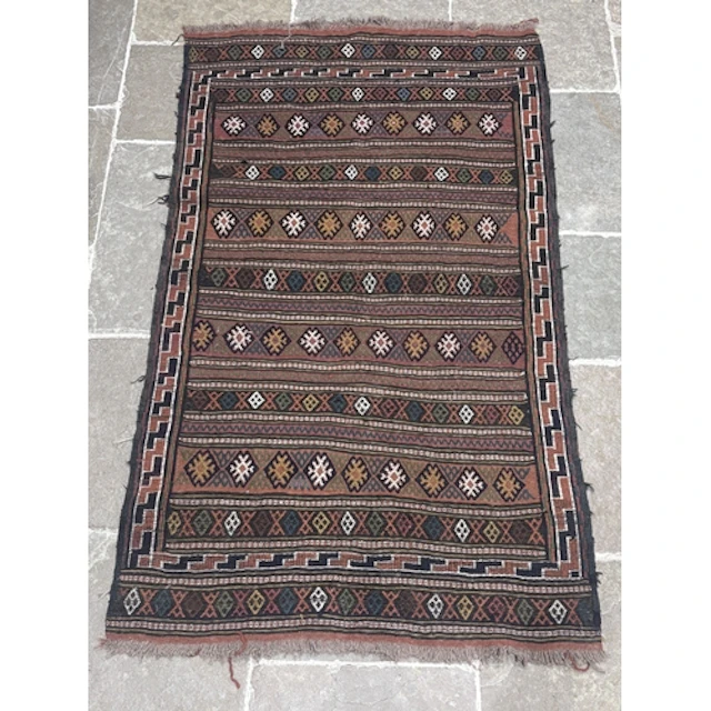 An Afghan Nomadic handwoven wool rug, in russet, blue, yello...